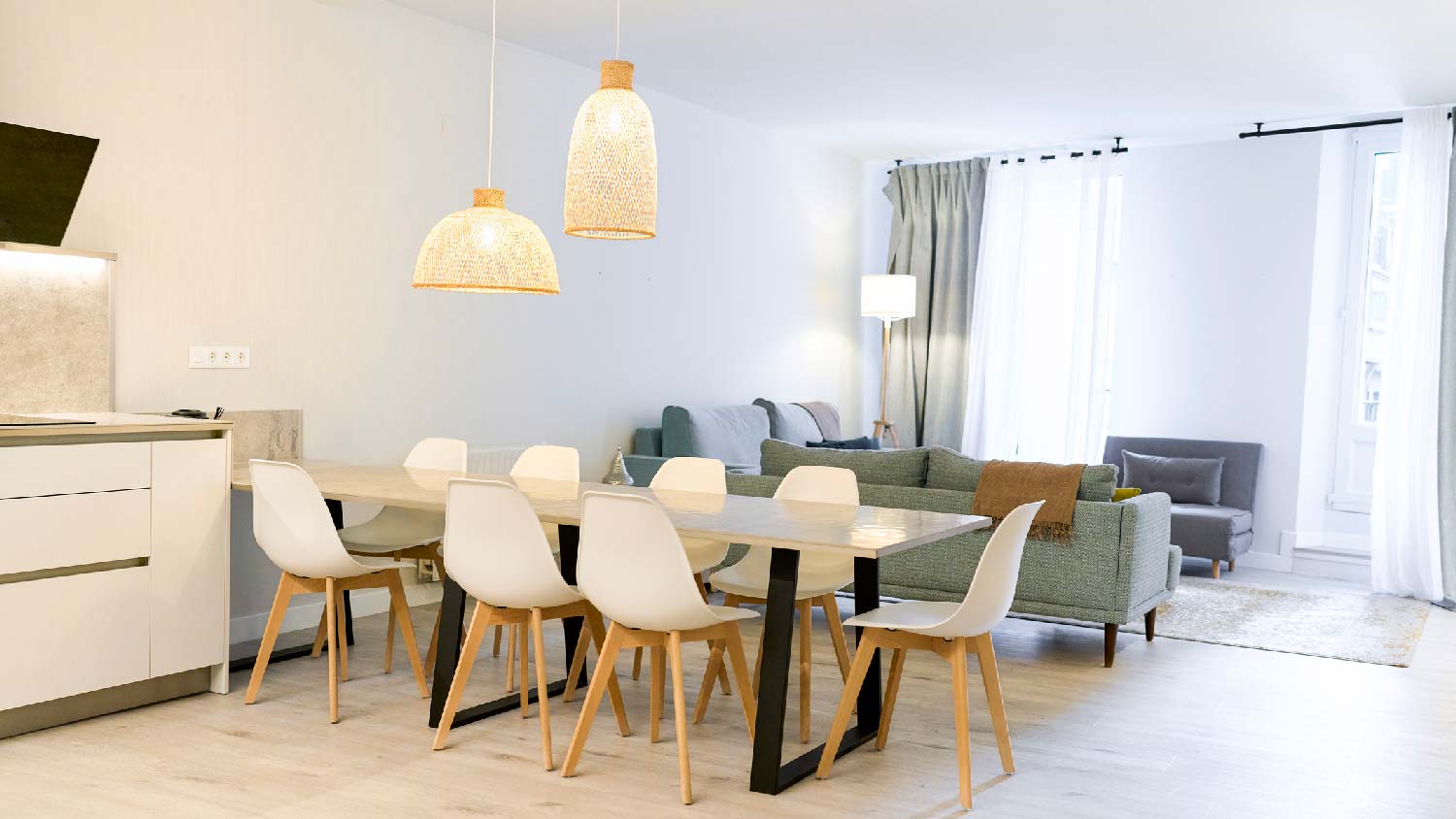 A dining area with two pendant lights over the table