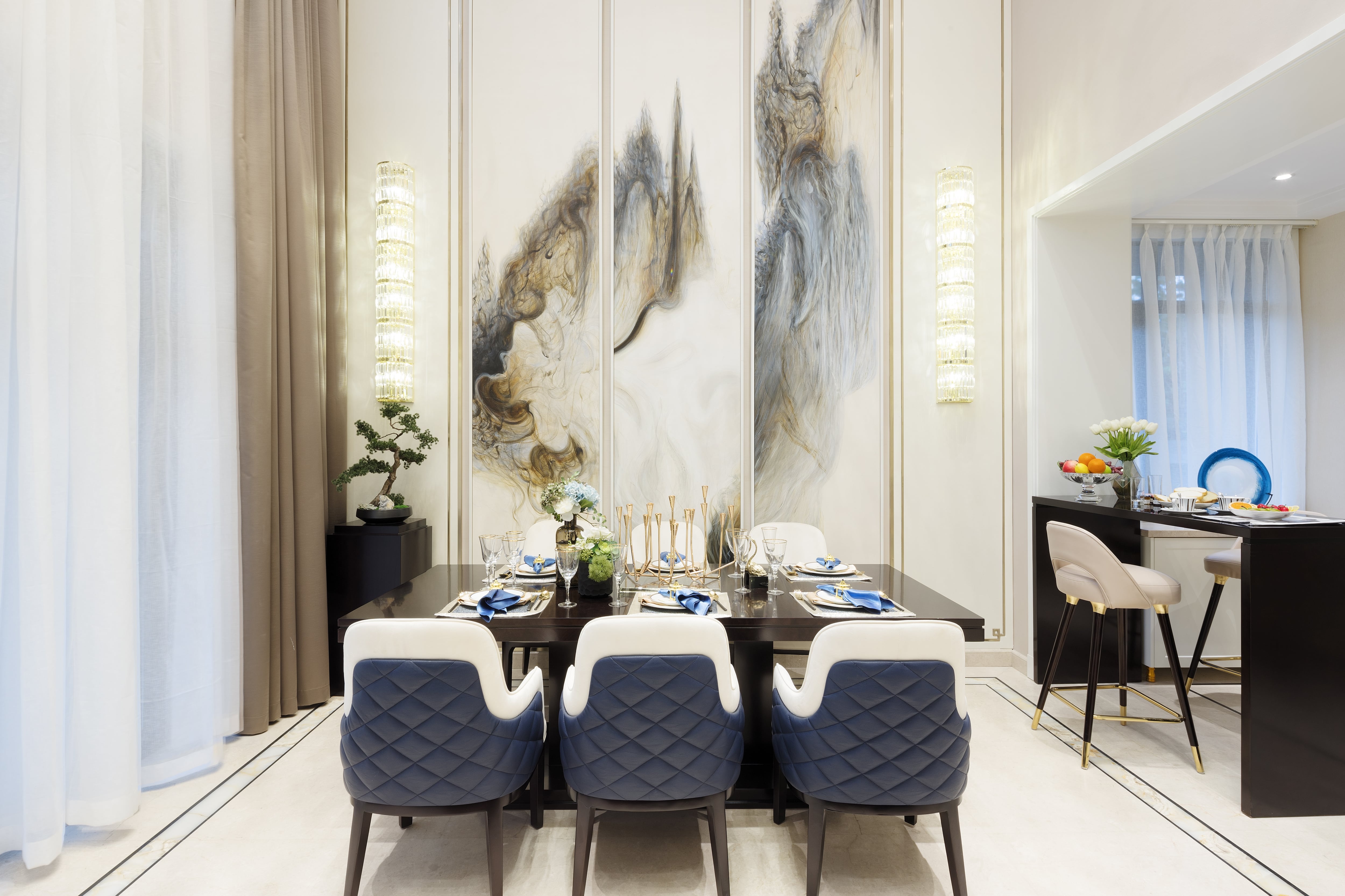 A modern dining room with a marble wall and rounded wall sconces