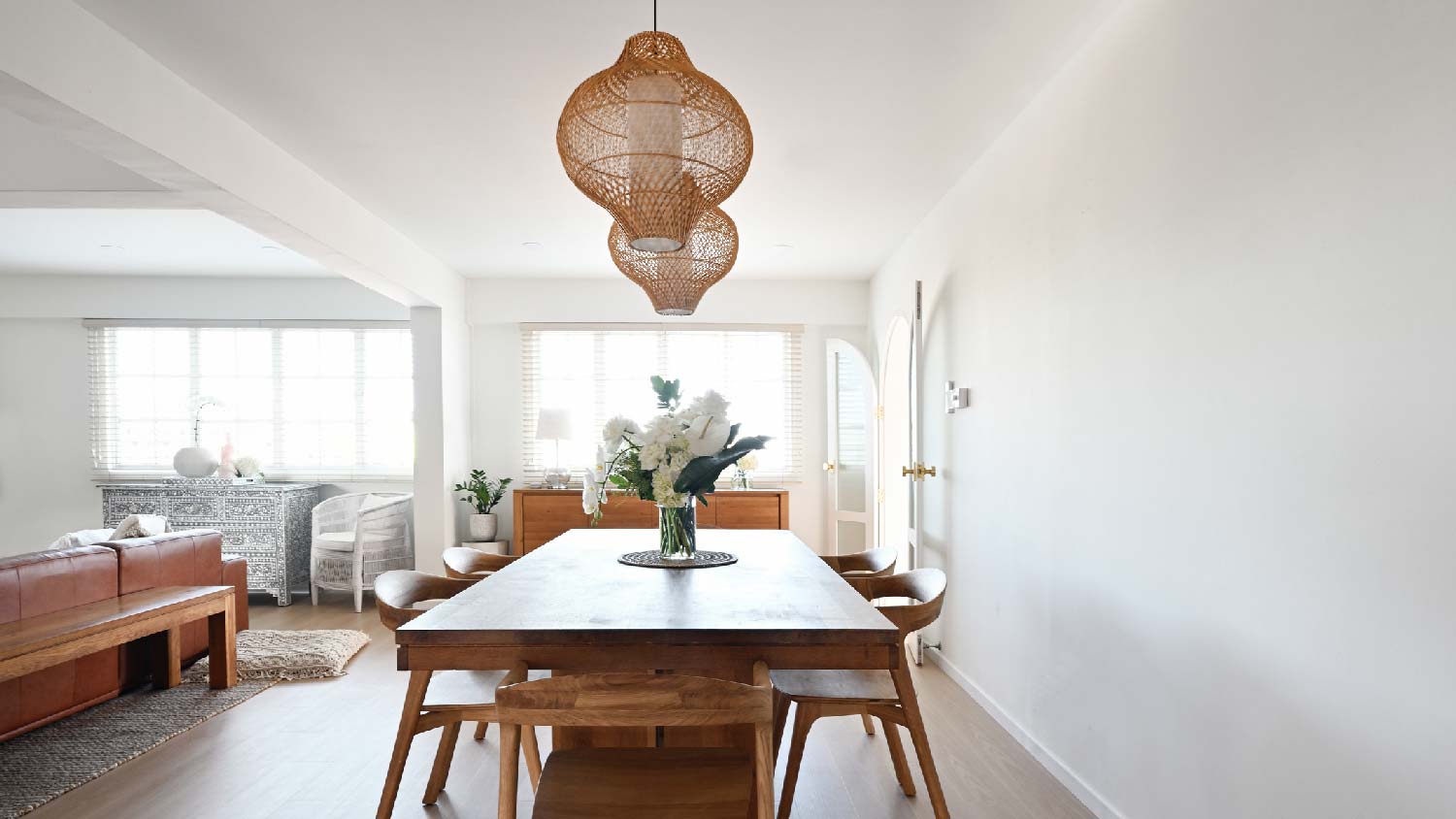 A dining room with a double pendant light above the table