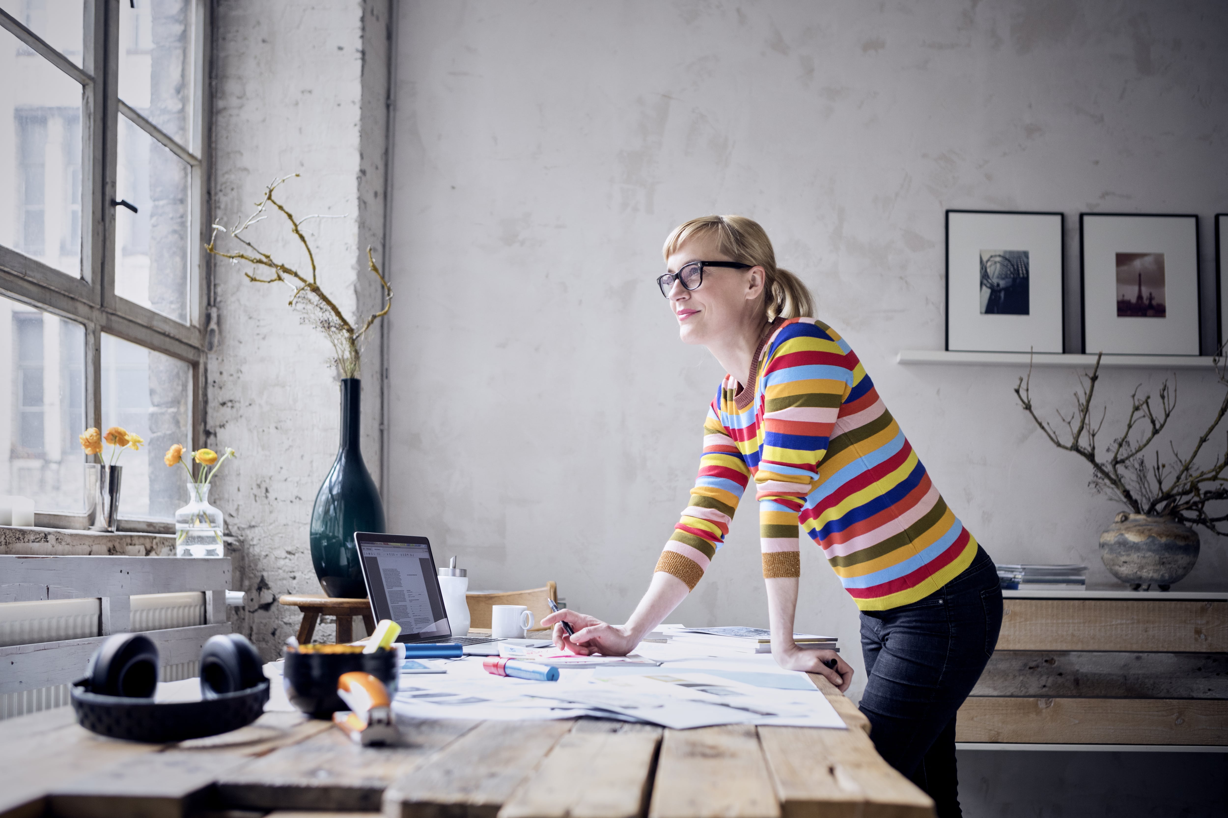 Woman standing at desk made from reclaimed wood