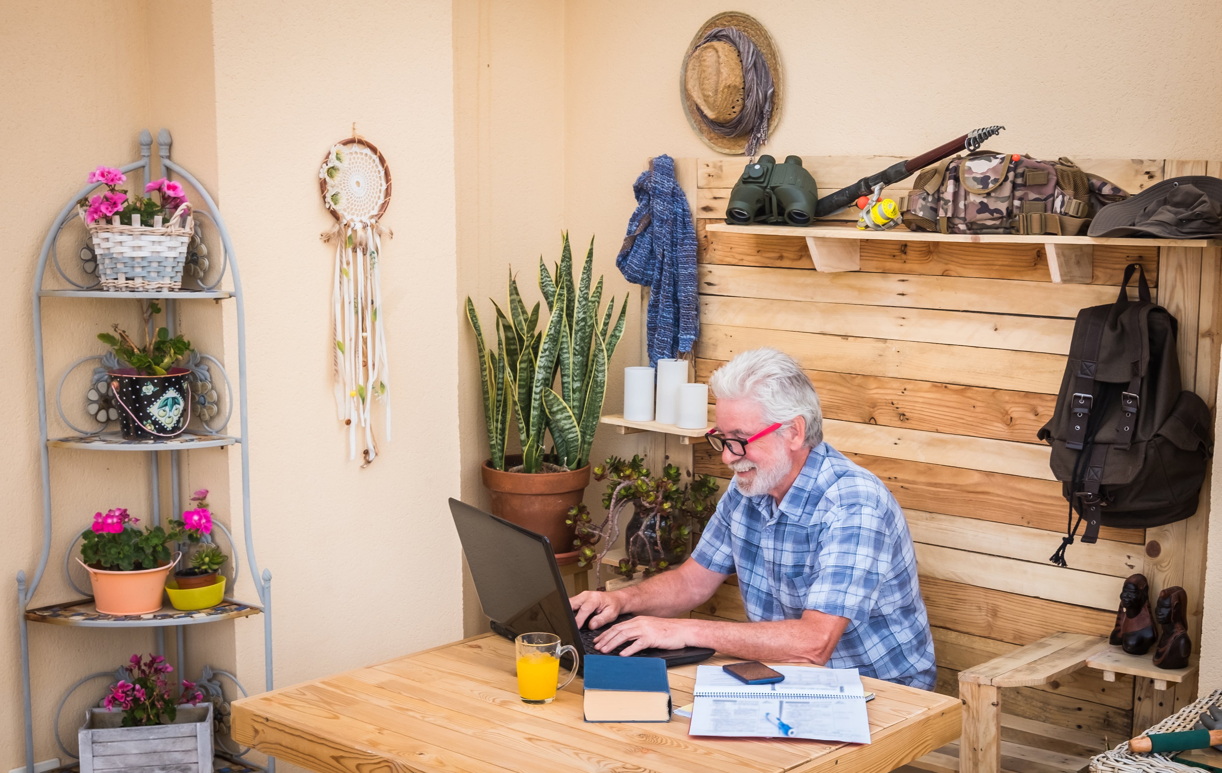 Man working at a pallet desk with a pallet wall behind it