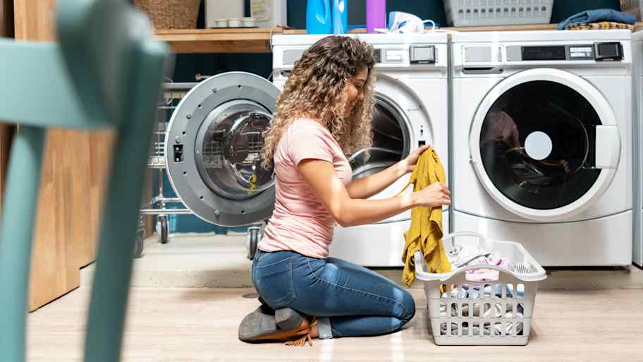 Woman using the washing machine at home