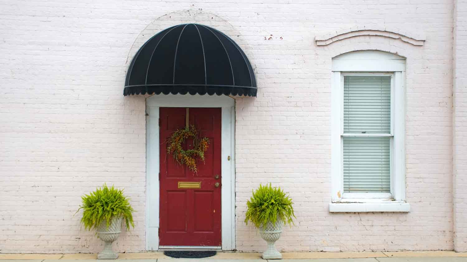 Domed awning installed above an entry door