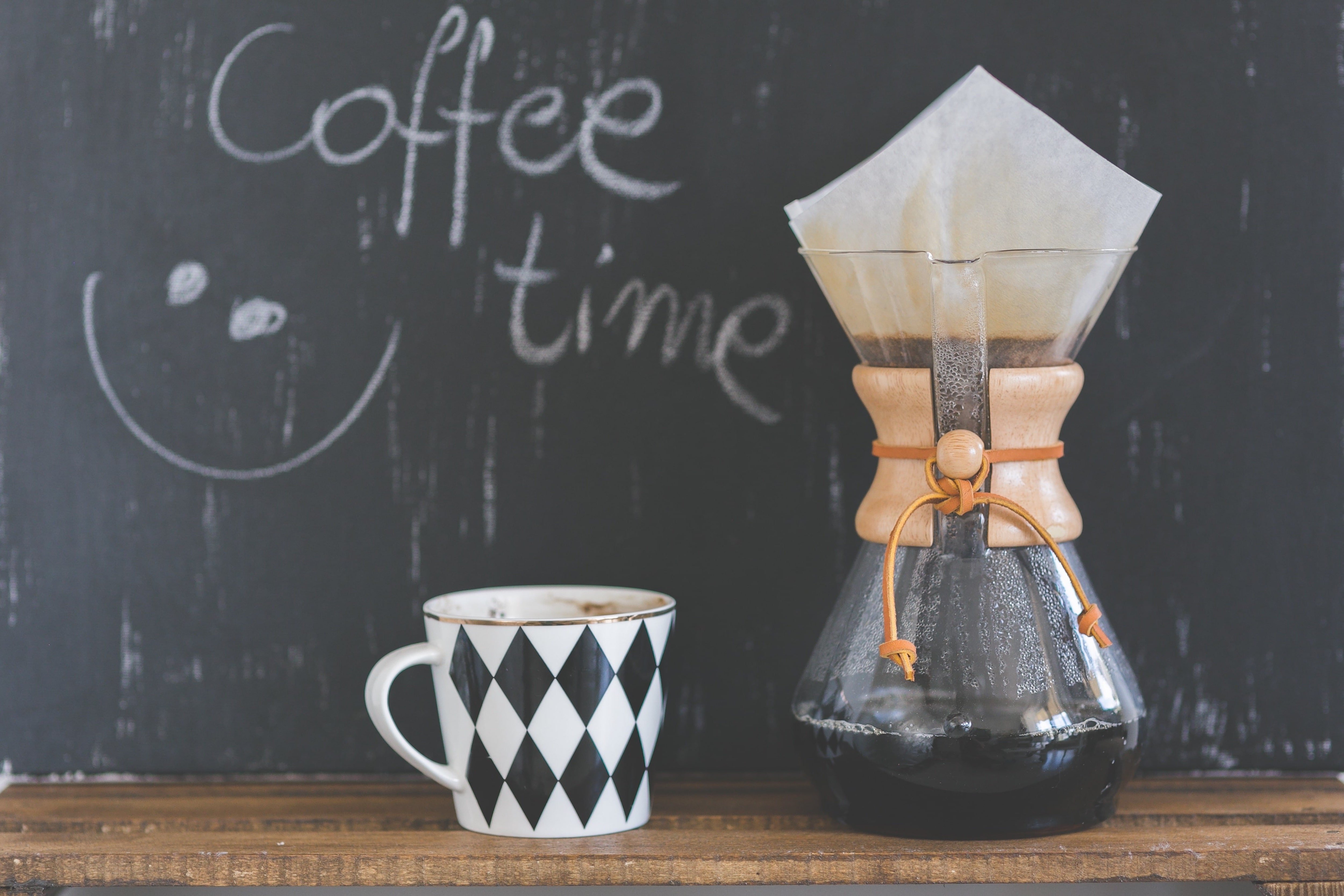 Coffee mug and coffee maker with chalkboard background