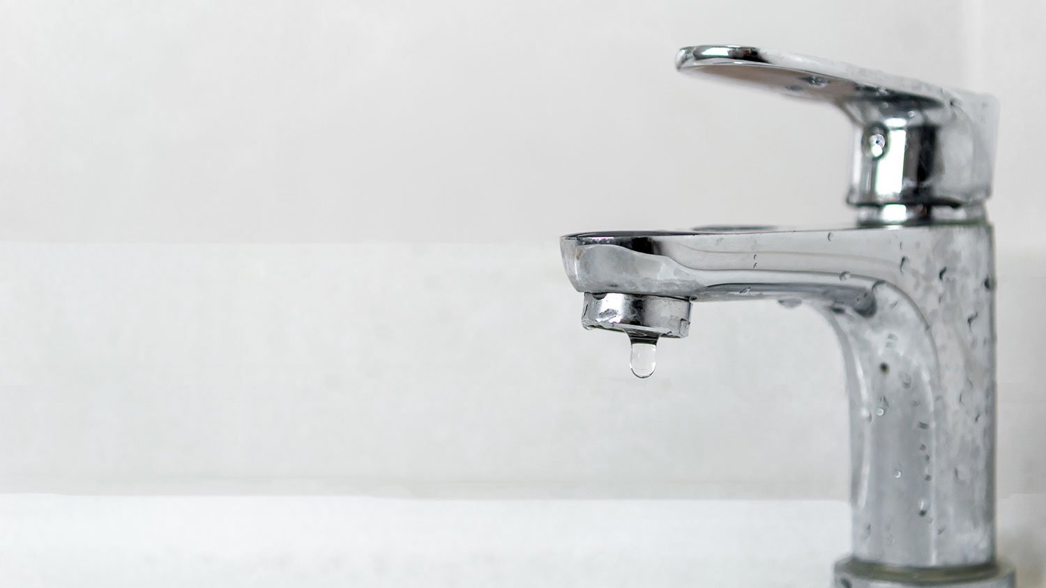 Closeup of a faucet with water dripping