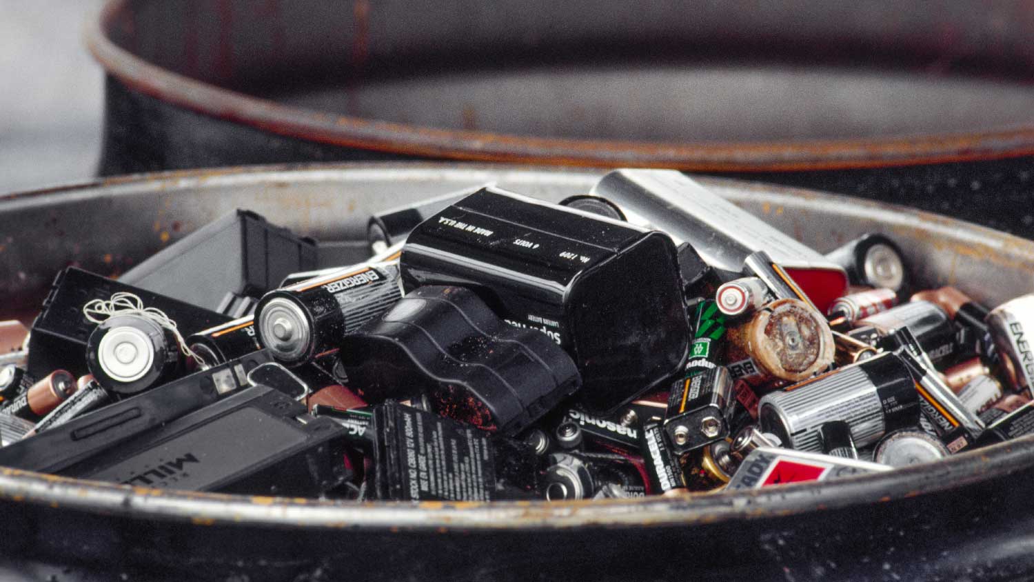 A gallon drum filled with batteries