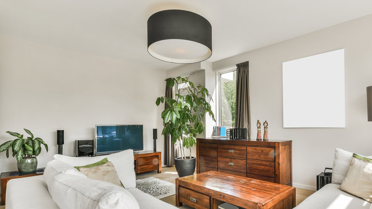 Modern room interior with sofa and table under lamp