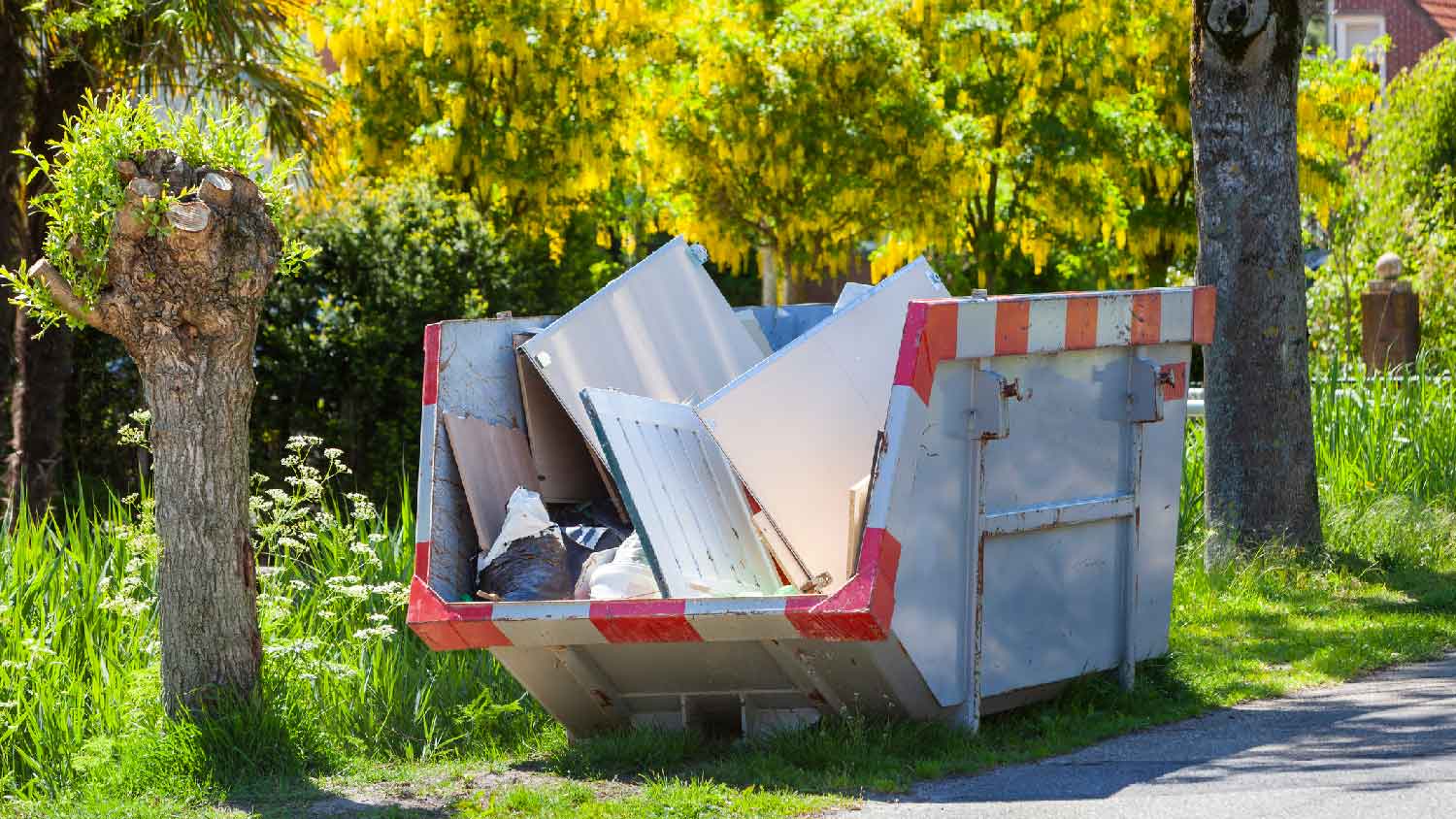 A dumpster outside a house