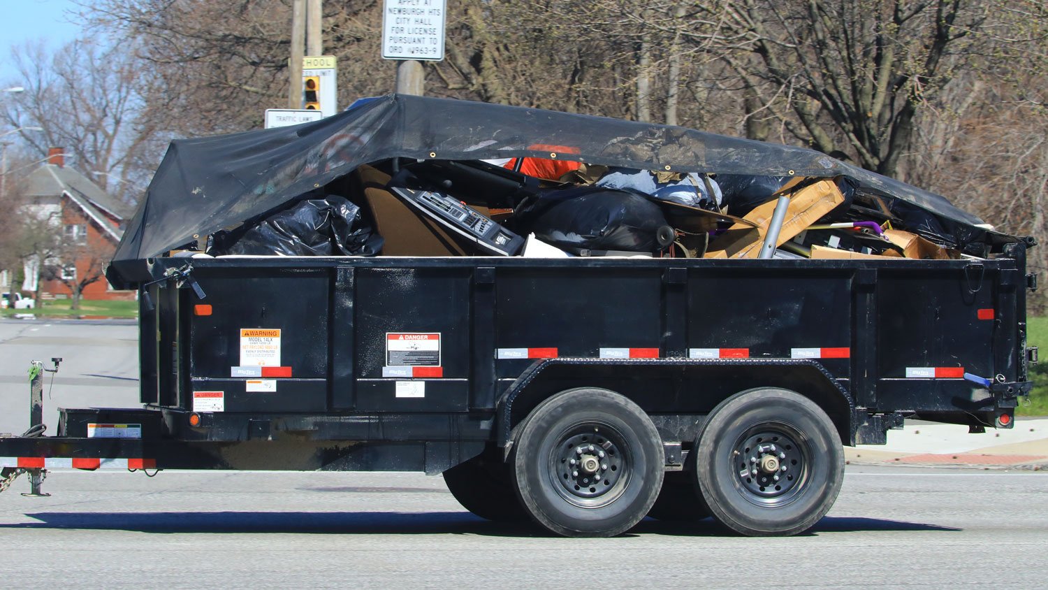 Cargo trailer being pulled with garbage and debris