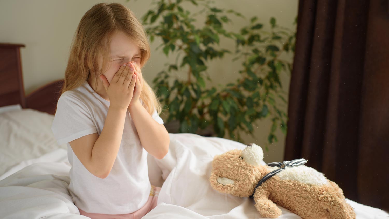 Little girl with dust mite allergy sneezing
