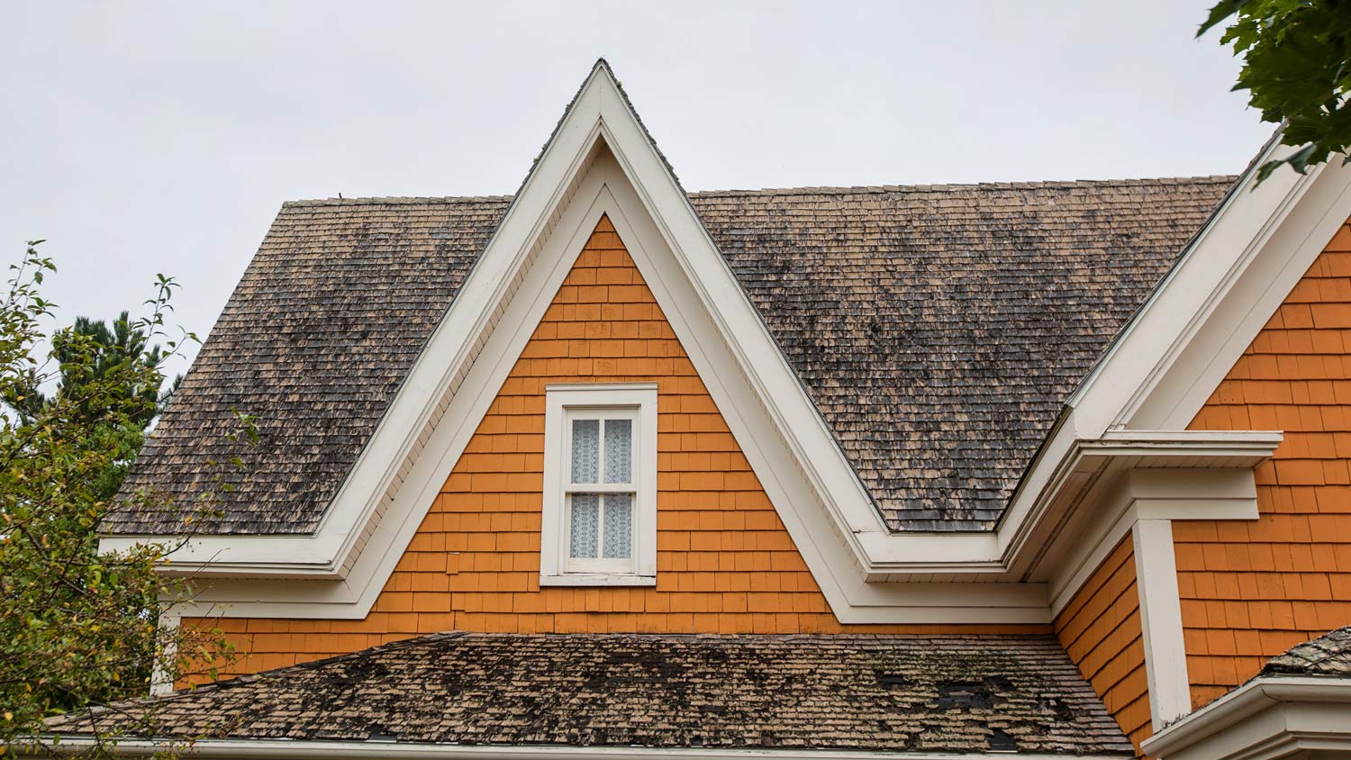 Older orange house with eaves