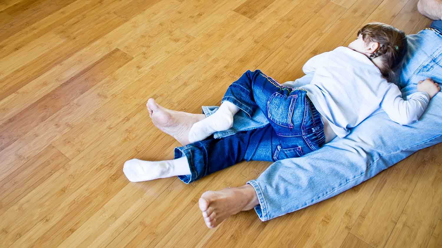 Father and child sitting on a bamboo floor