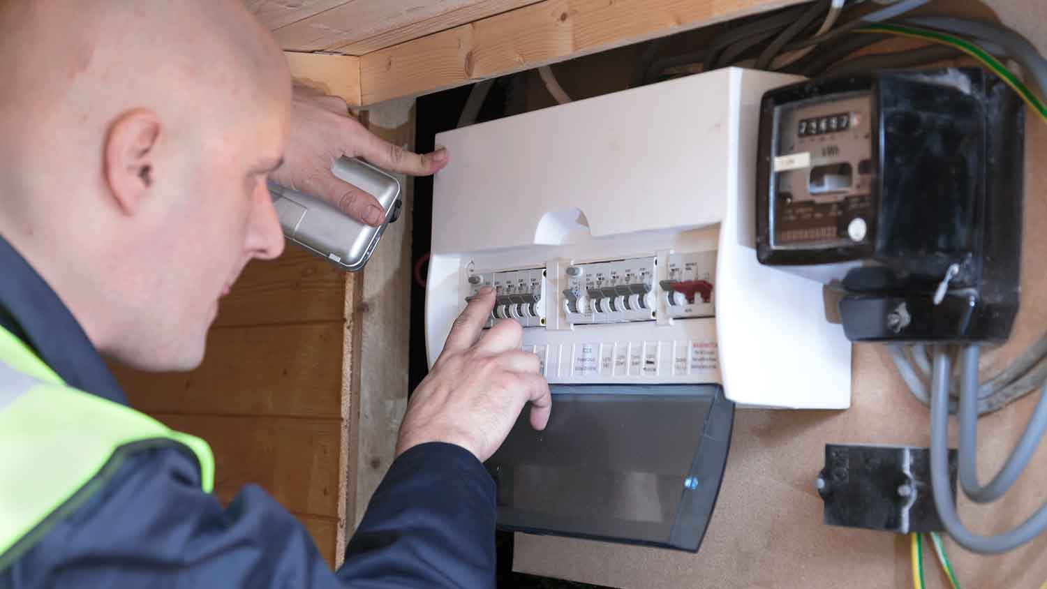 Electrician checking residential circuit breaker box