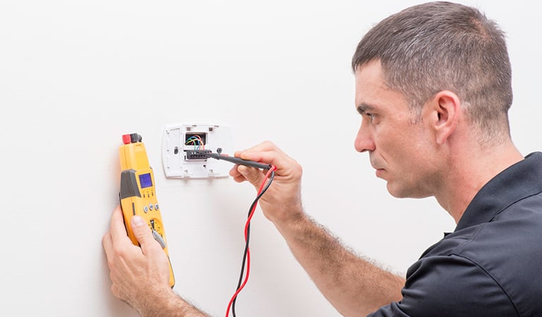 Electrician checks voltage