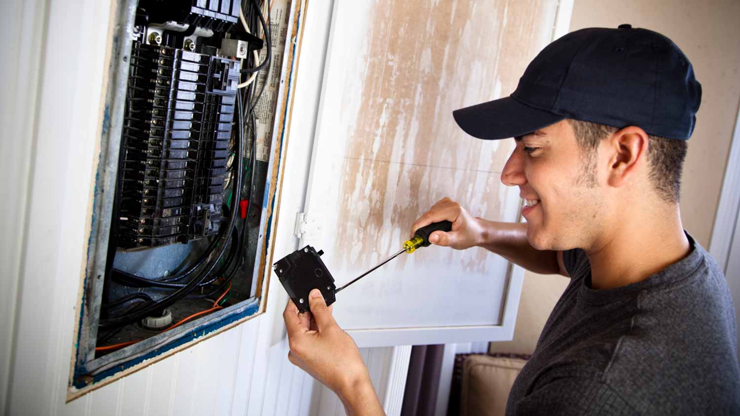 An electrician installing a new circuit breaker