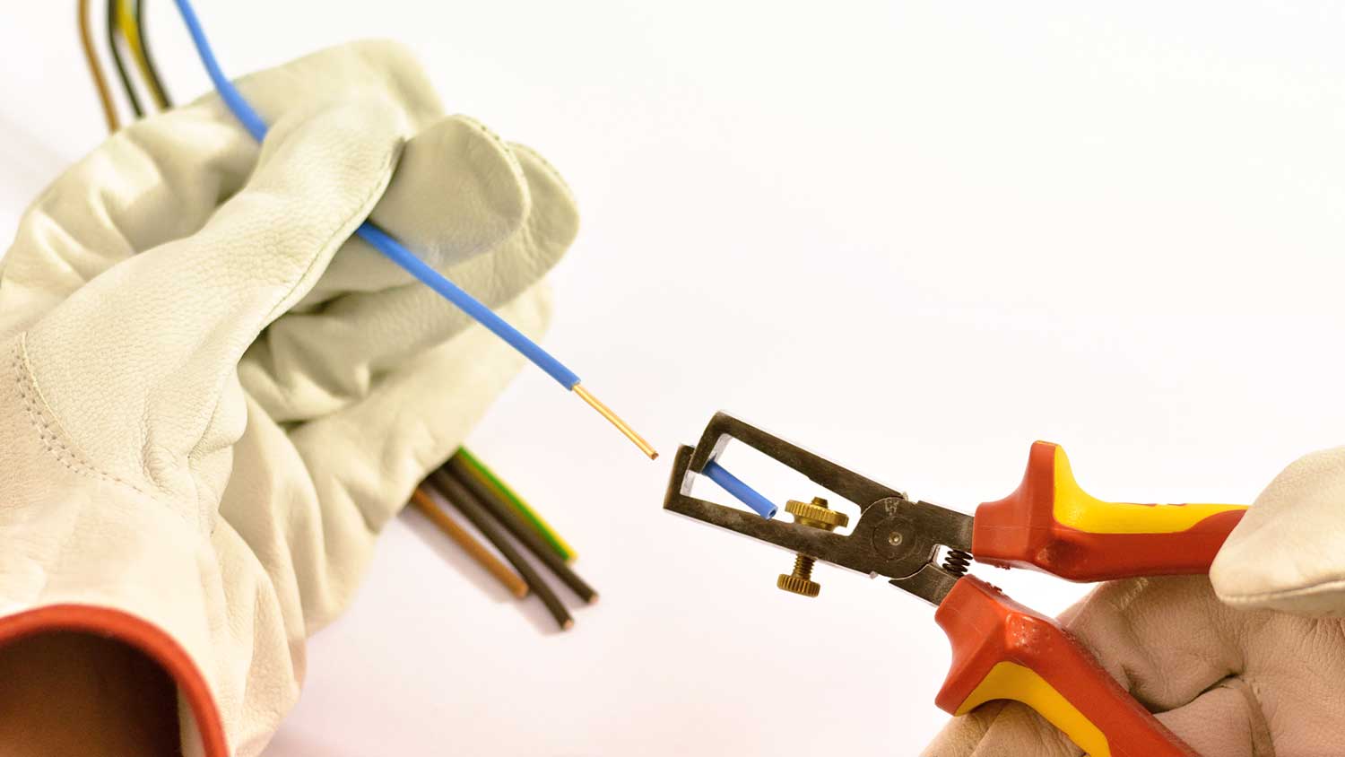 Electrician stripping insulation on an electrical wire