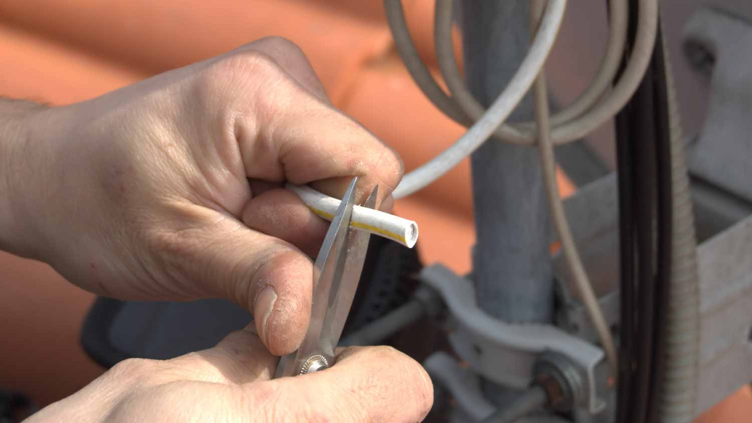 A electrician using scissors