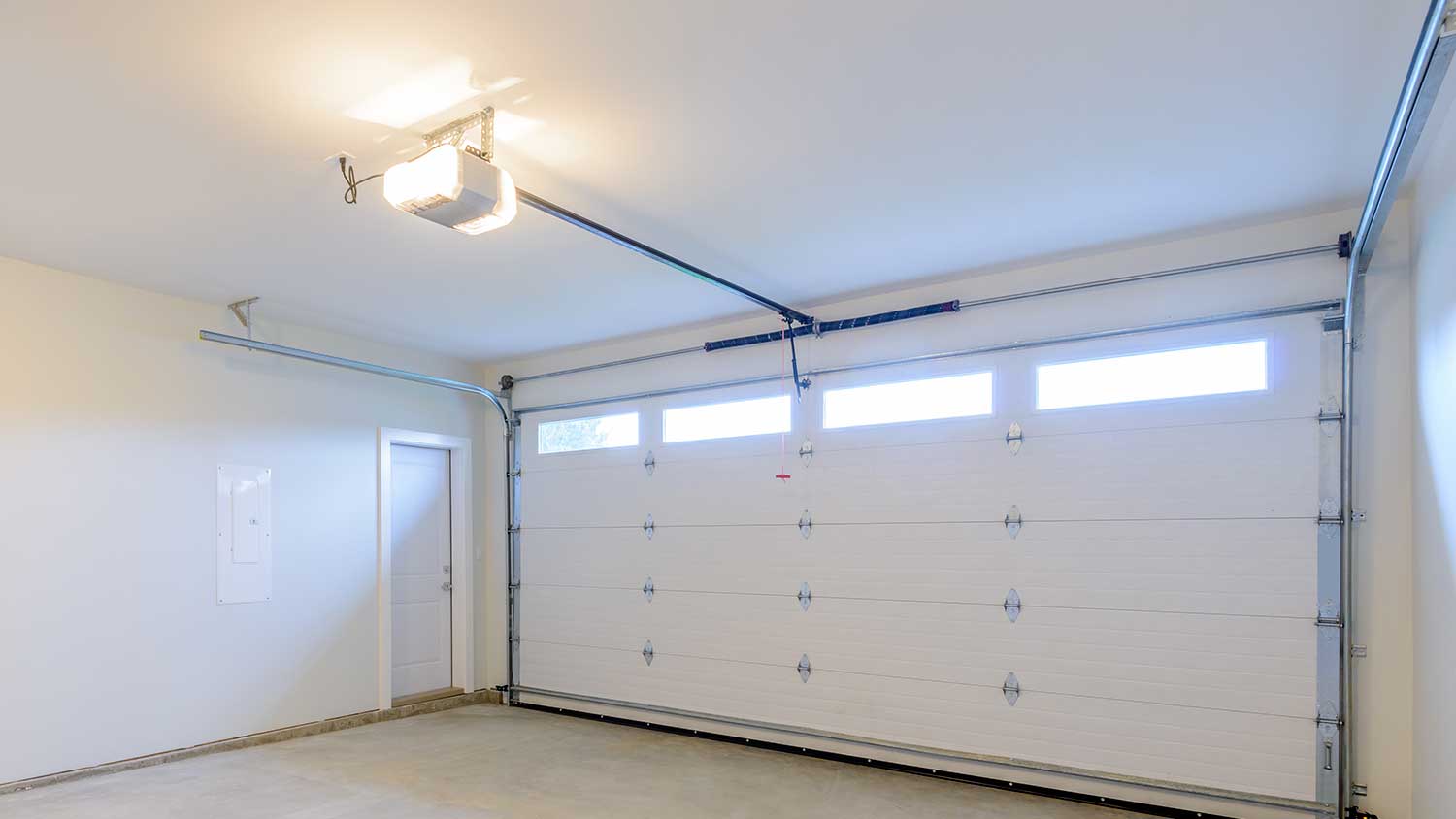 Empty garage interior with automatic garage door  