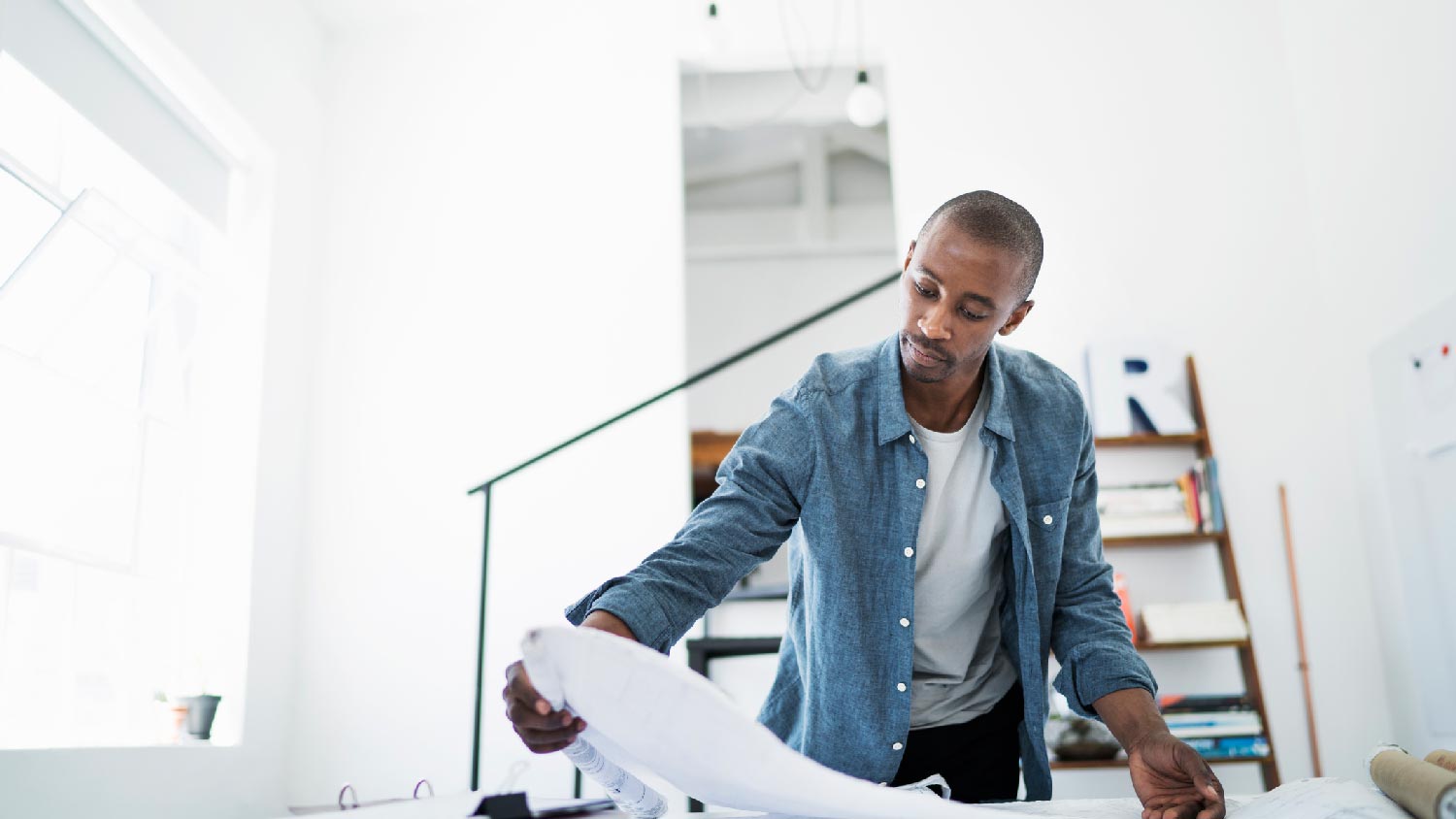 An engineer checking a house’s blueprints