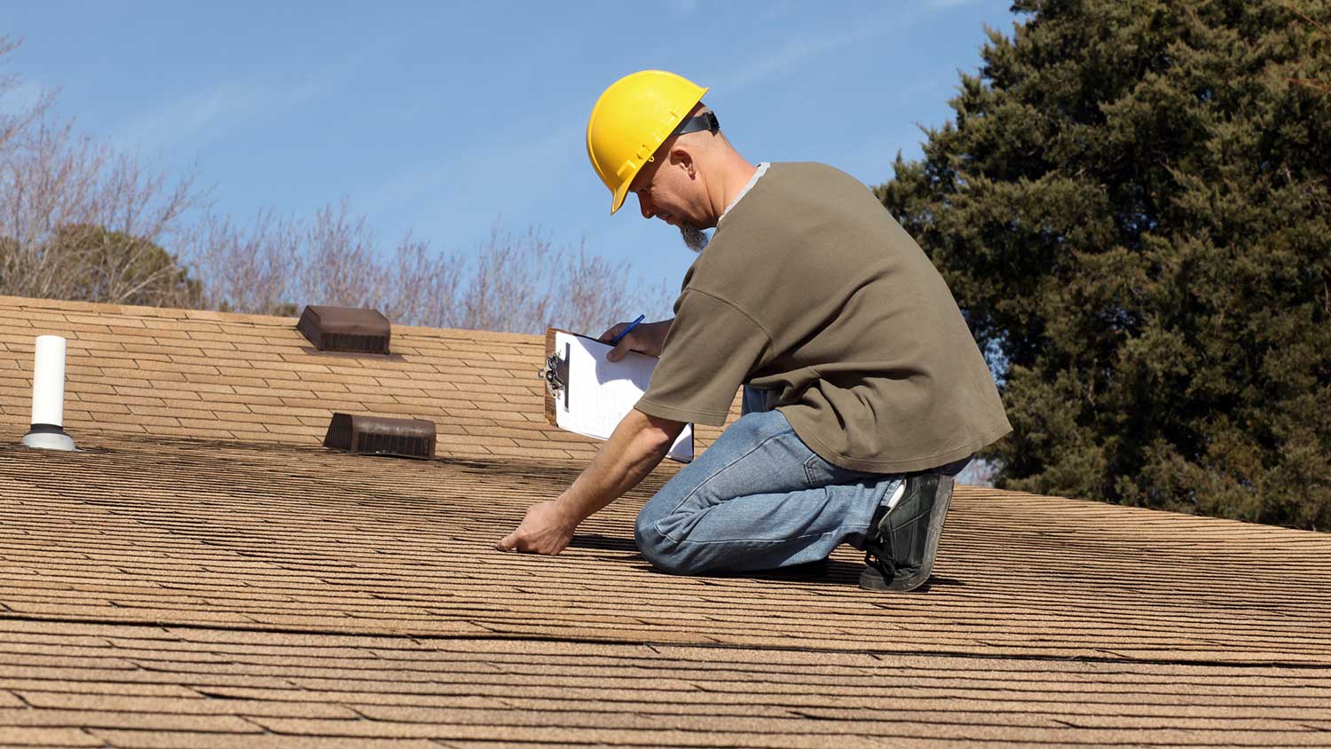 Engineer inspecting the roof of a house