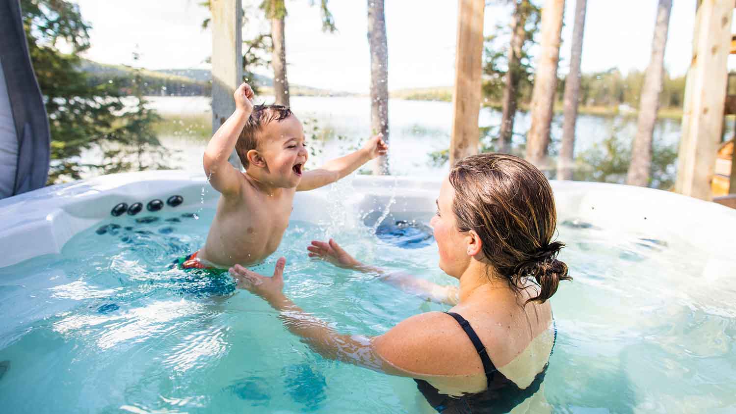 Mother and son having fun in the swim spa