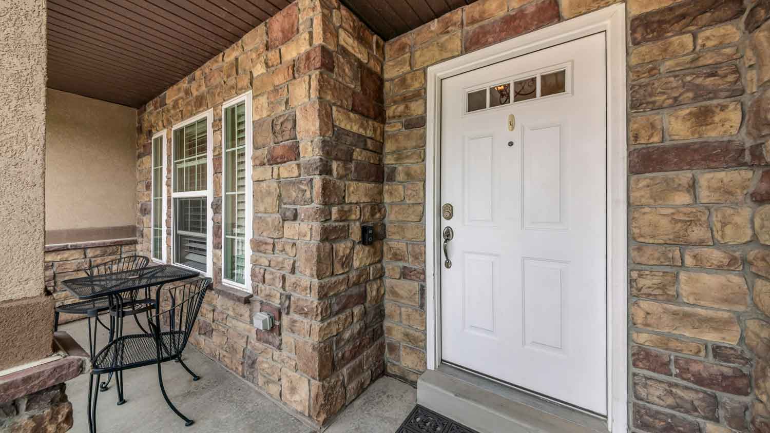 A house entrance with stone veneer siding