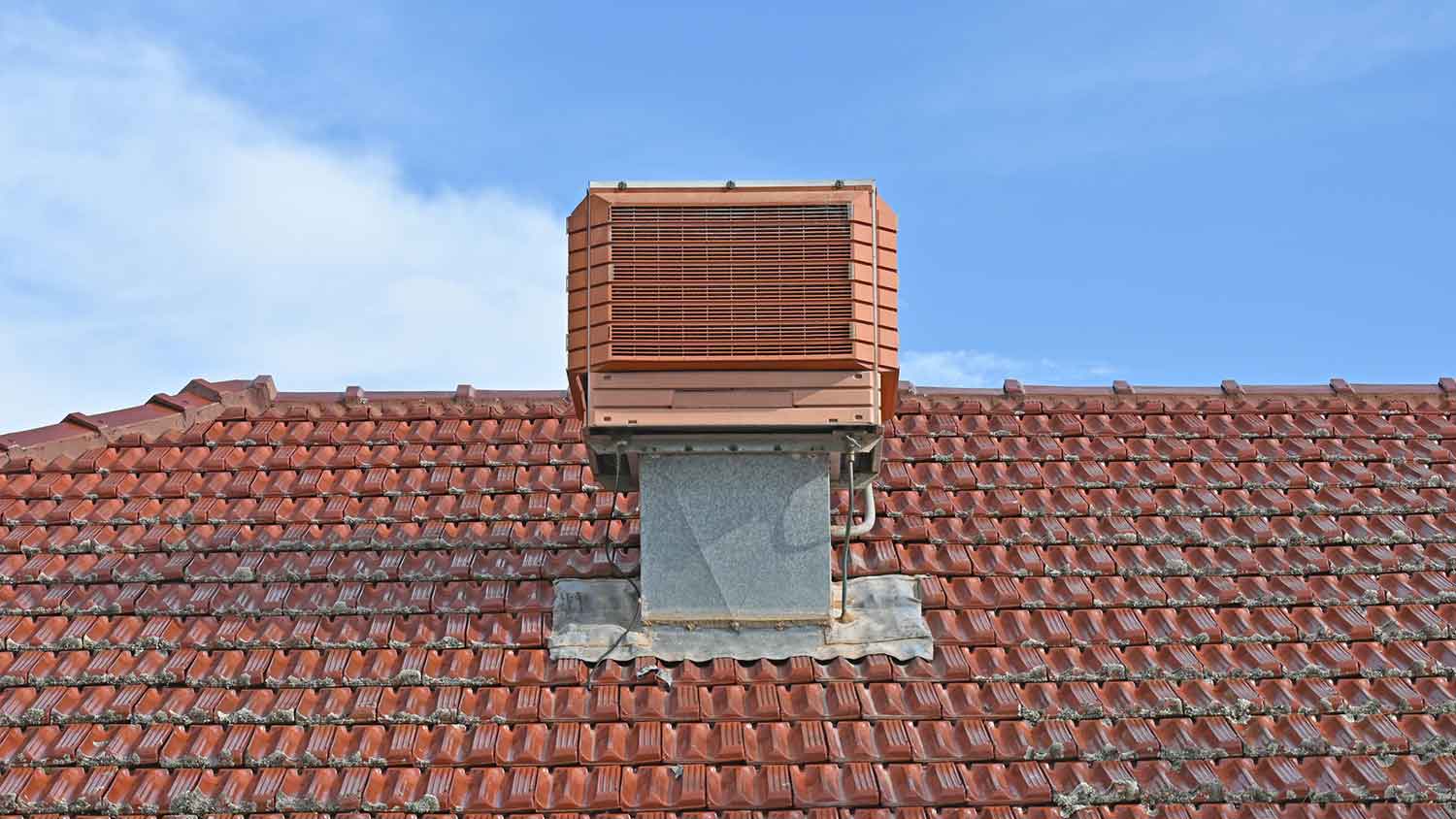 Evaporative air cooler installed on the roof of the house