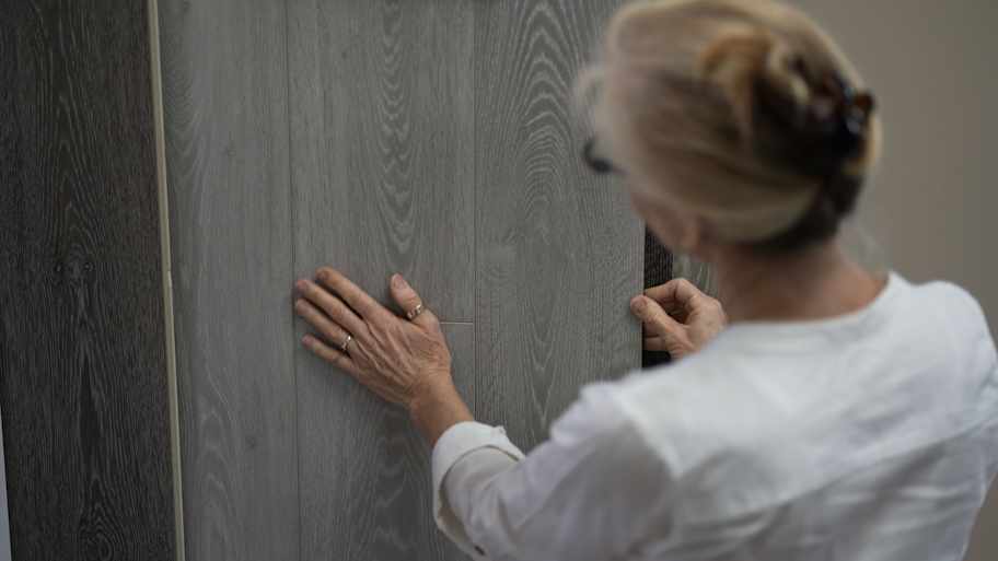 woman looking at floor plank samples