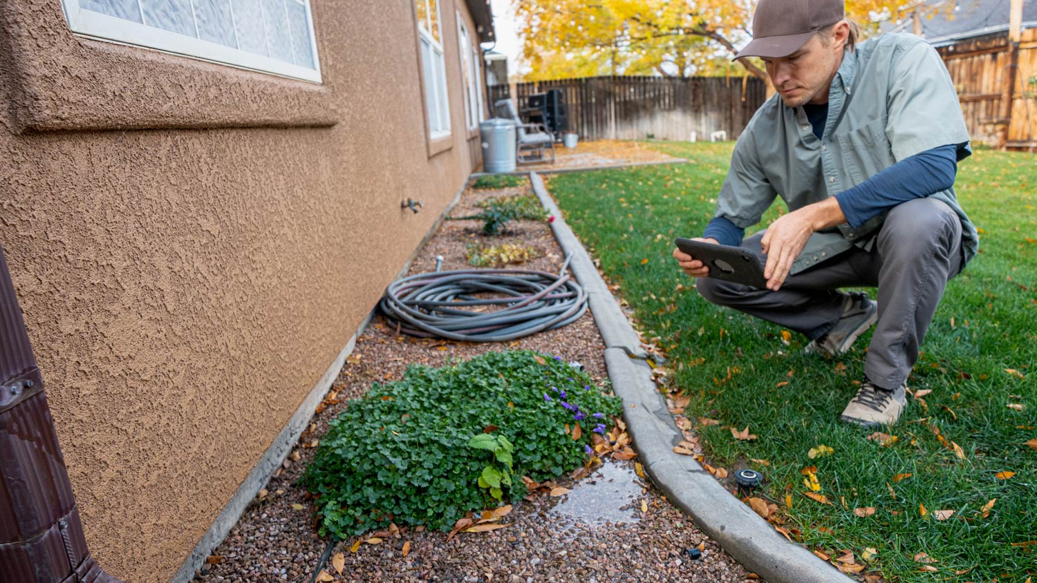 Man examining exterior of house