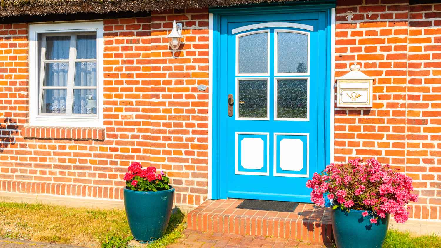 The exterior of a house with a blue front door