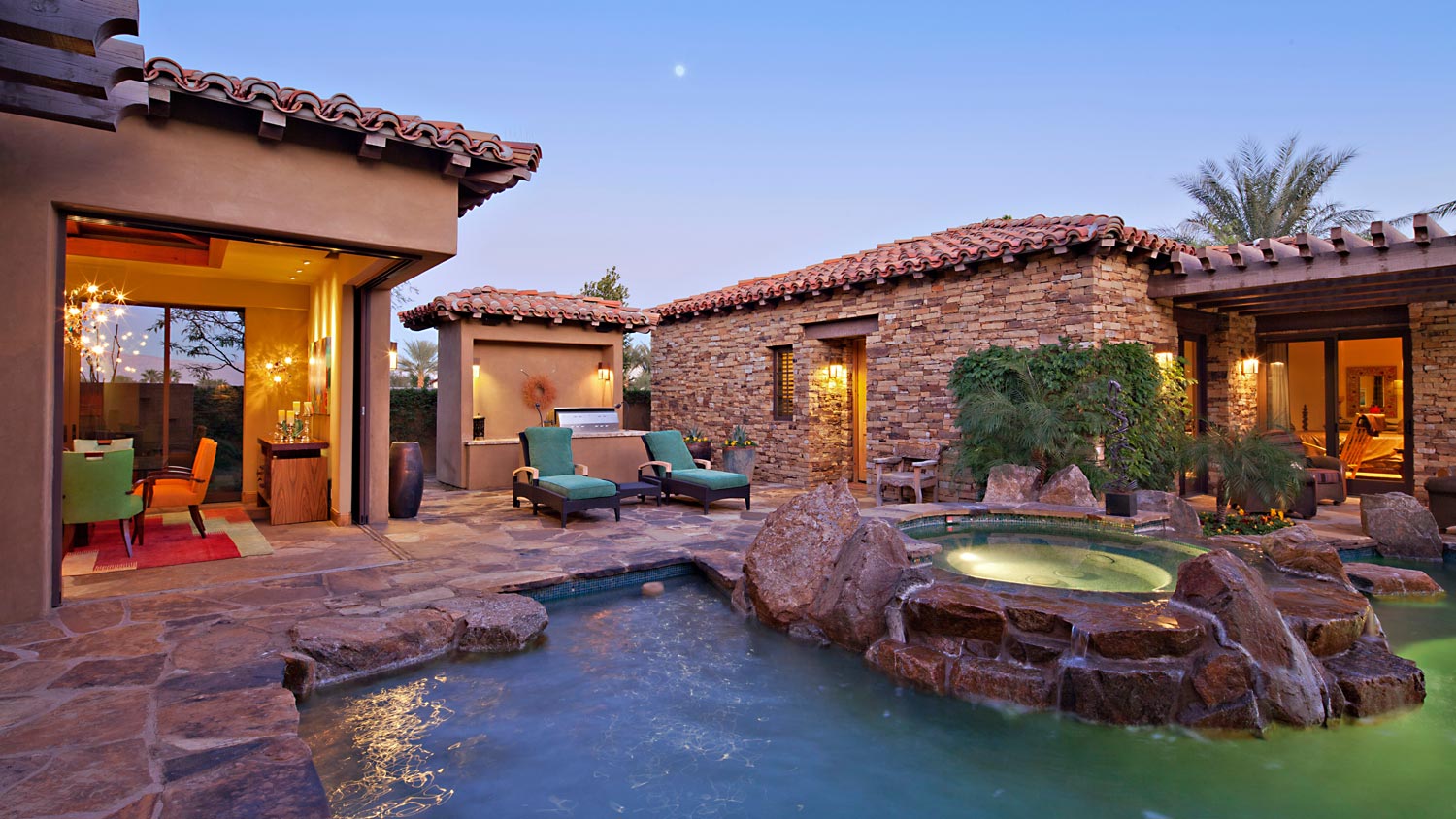 The exterior of a house with a pool and a hot tub