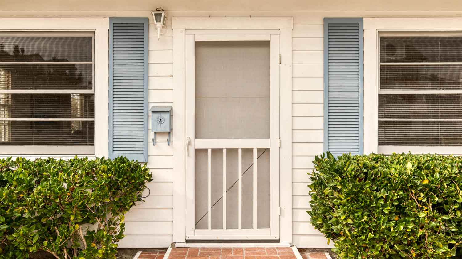 The exterior of a house with a screen door