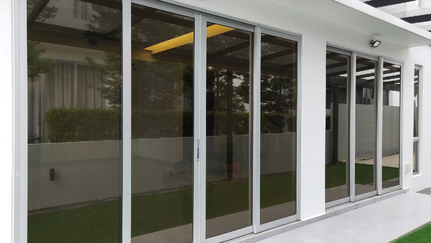 The exterior of a house with tinted glass doors