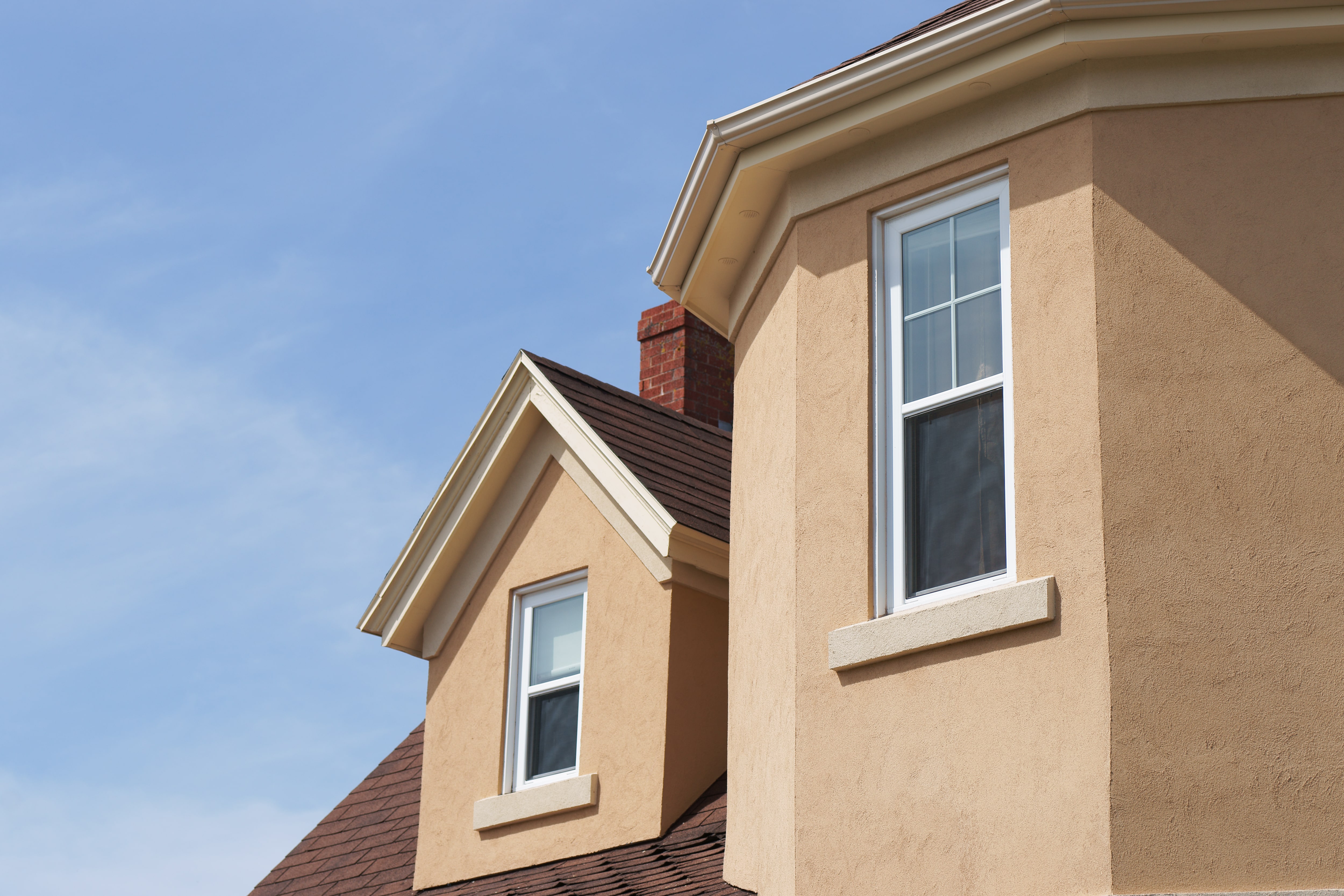 Stucco home with stucco window apron