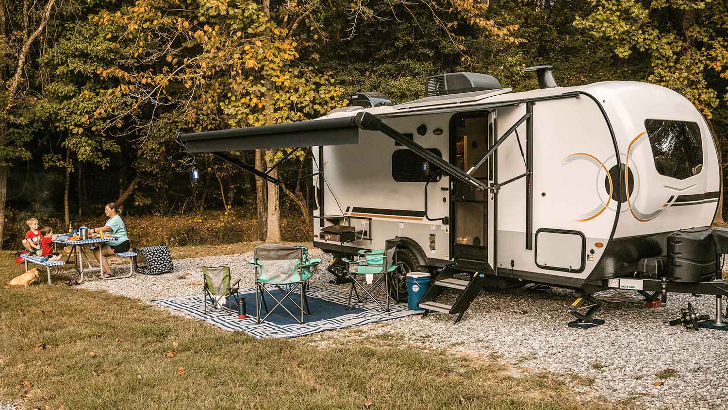 Family enjoying a meal outside of the camper