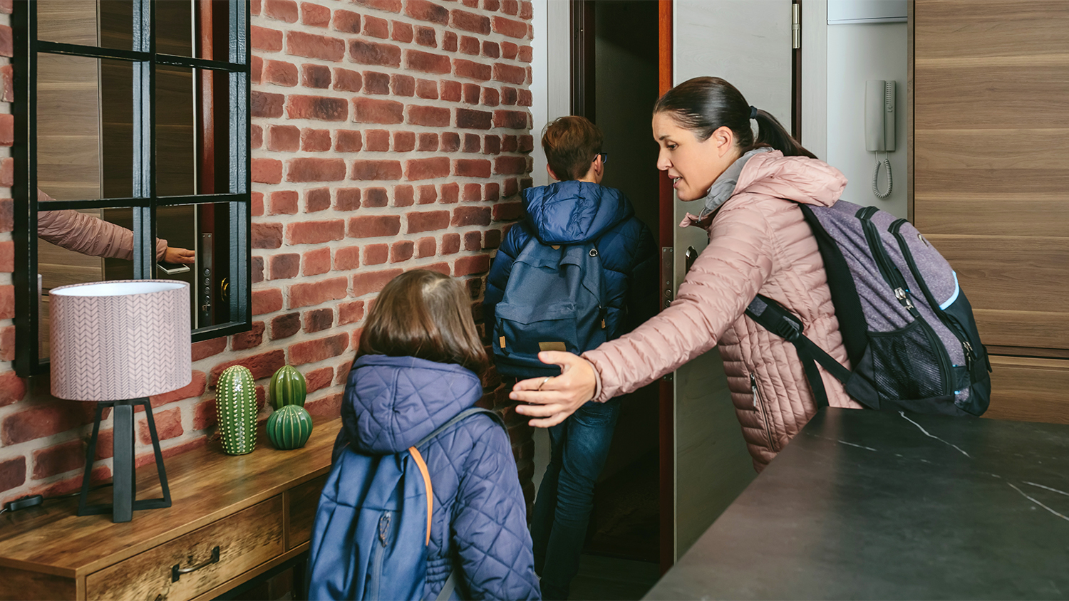 mother helps get kids out the door for emergency