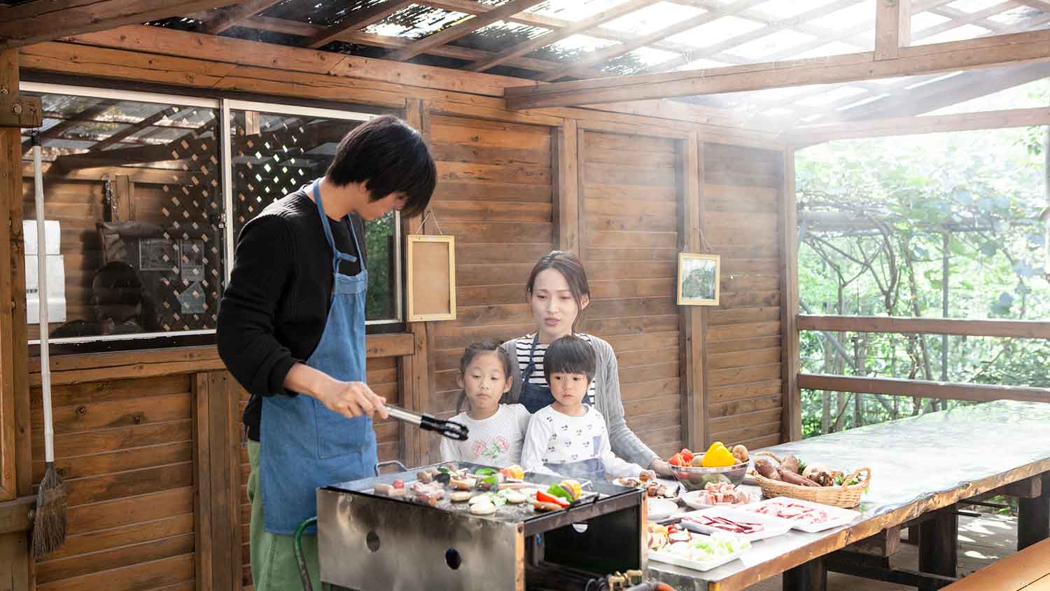 Family in covered outdoor kitchen enjoying a meal