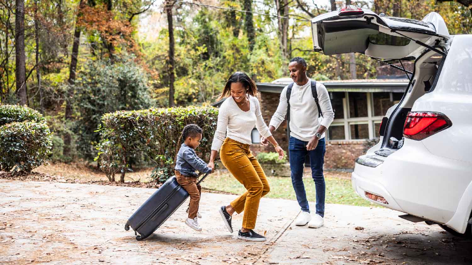 A family of three leaving the house