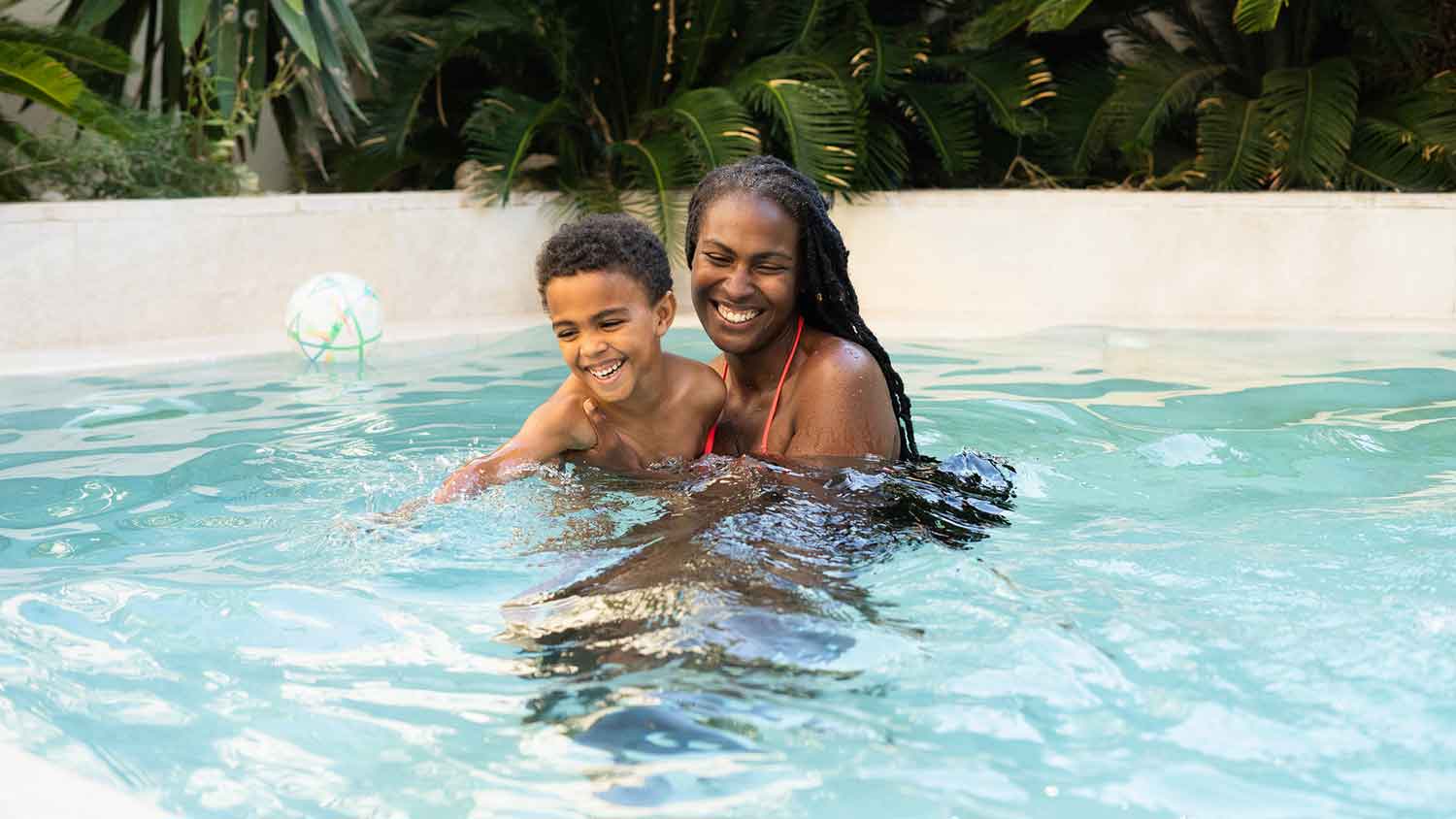 Mother and child playing in a swimming pool