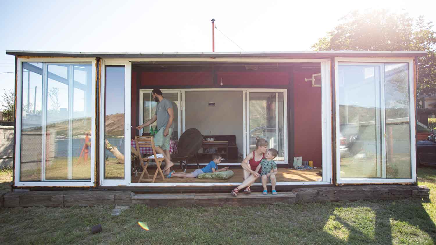 A family of four living in a shipping container house