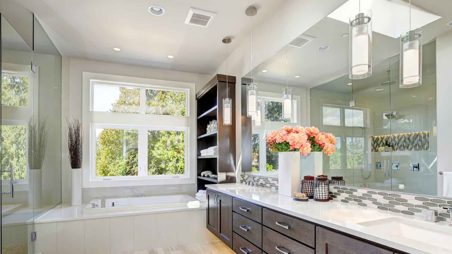 A modern bathroom with a brown wood vanity
