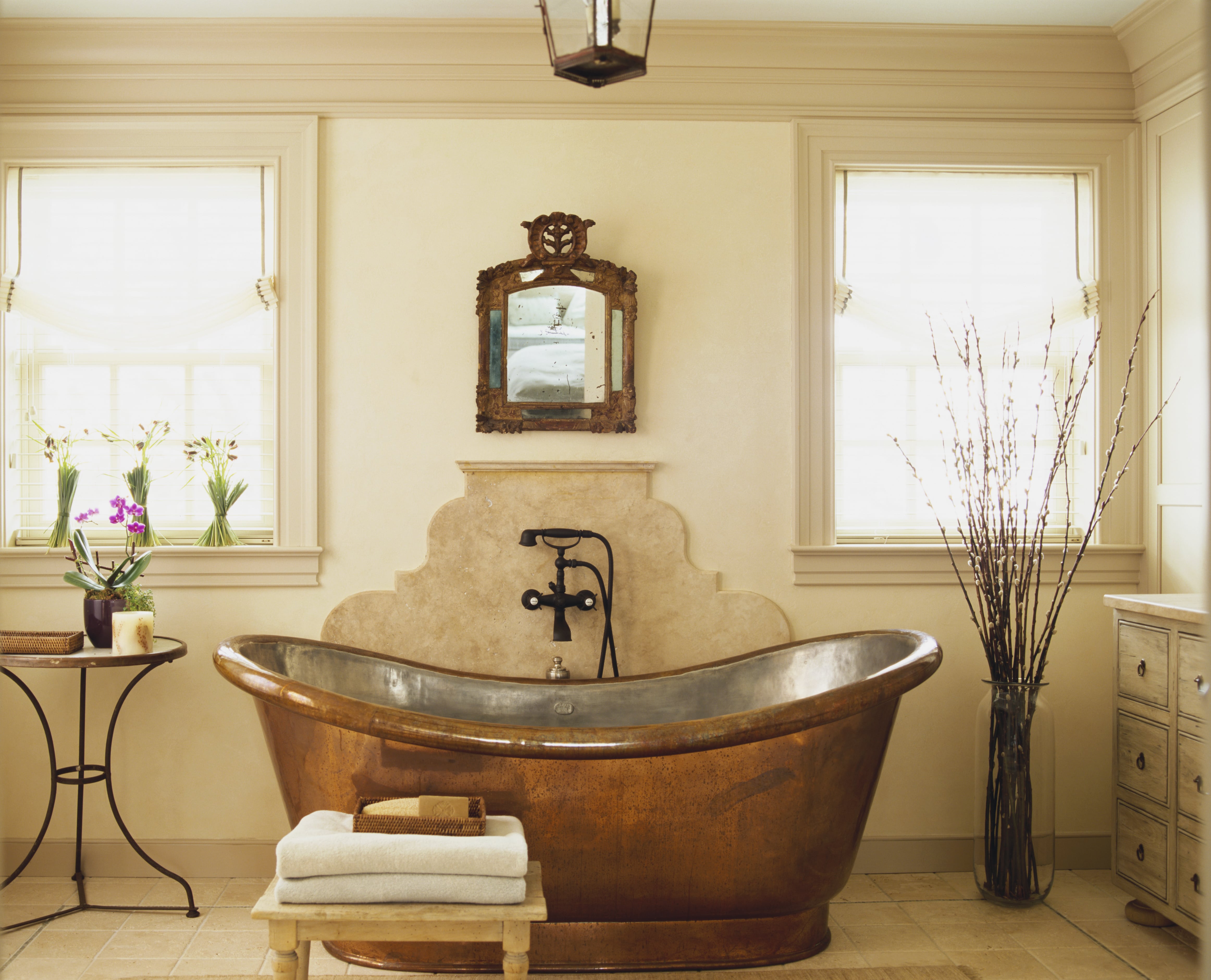 A warm colored bathroom with a rich copper tub