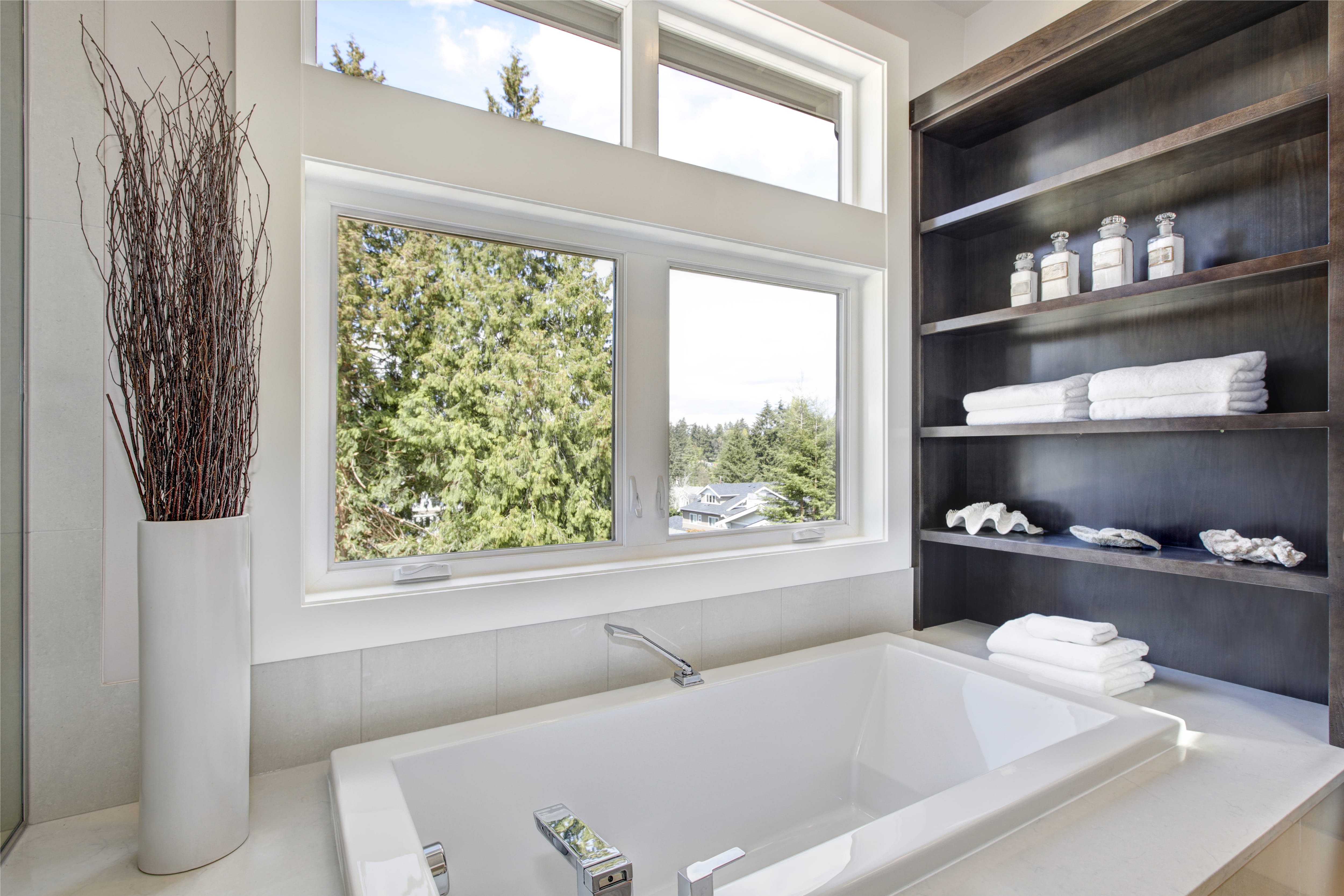 A drop in tub with industrial shelving on one side