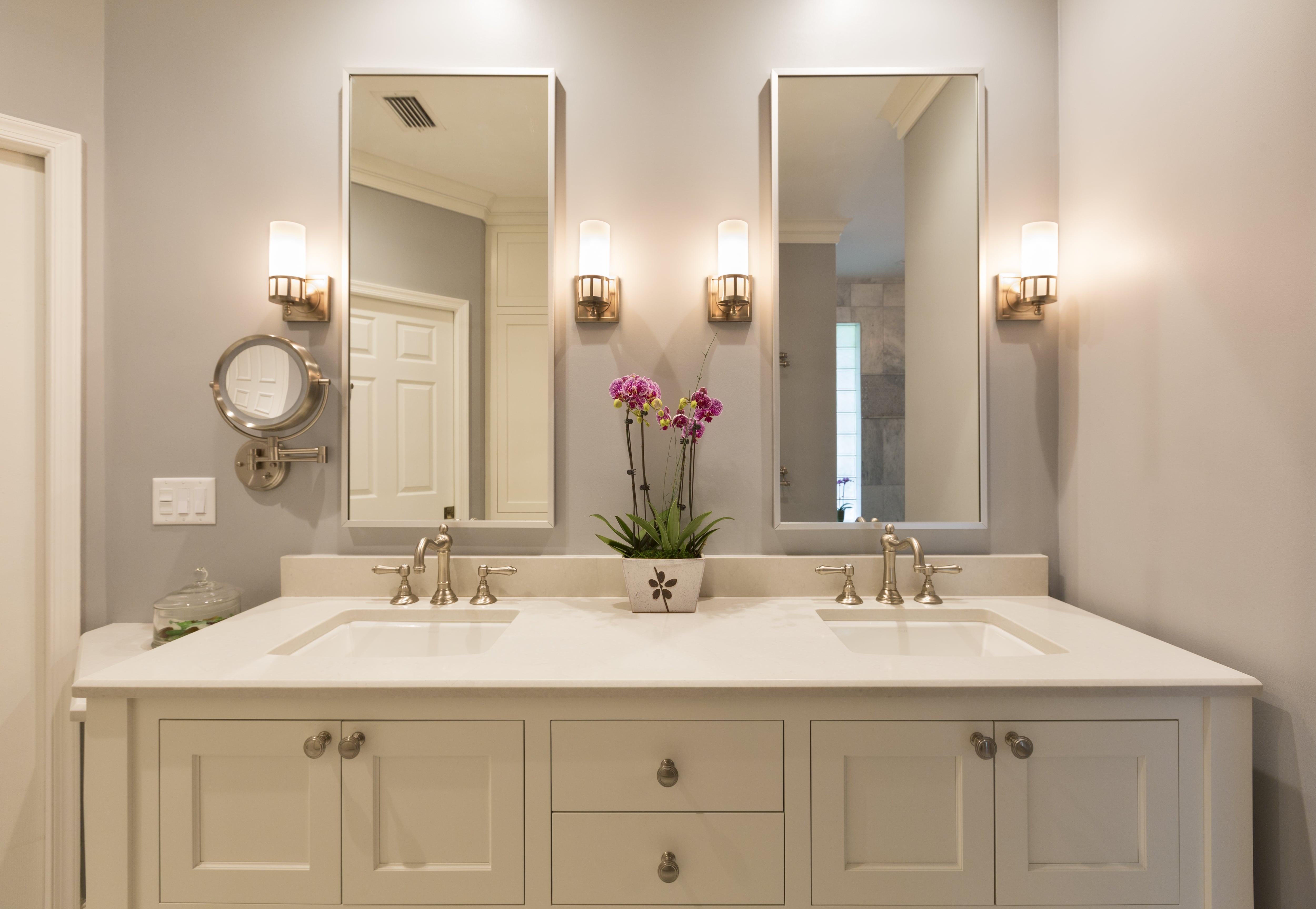 A lovely bathroom vanity with sconce lights