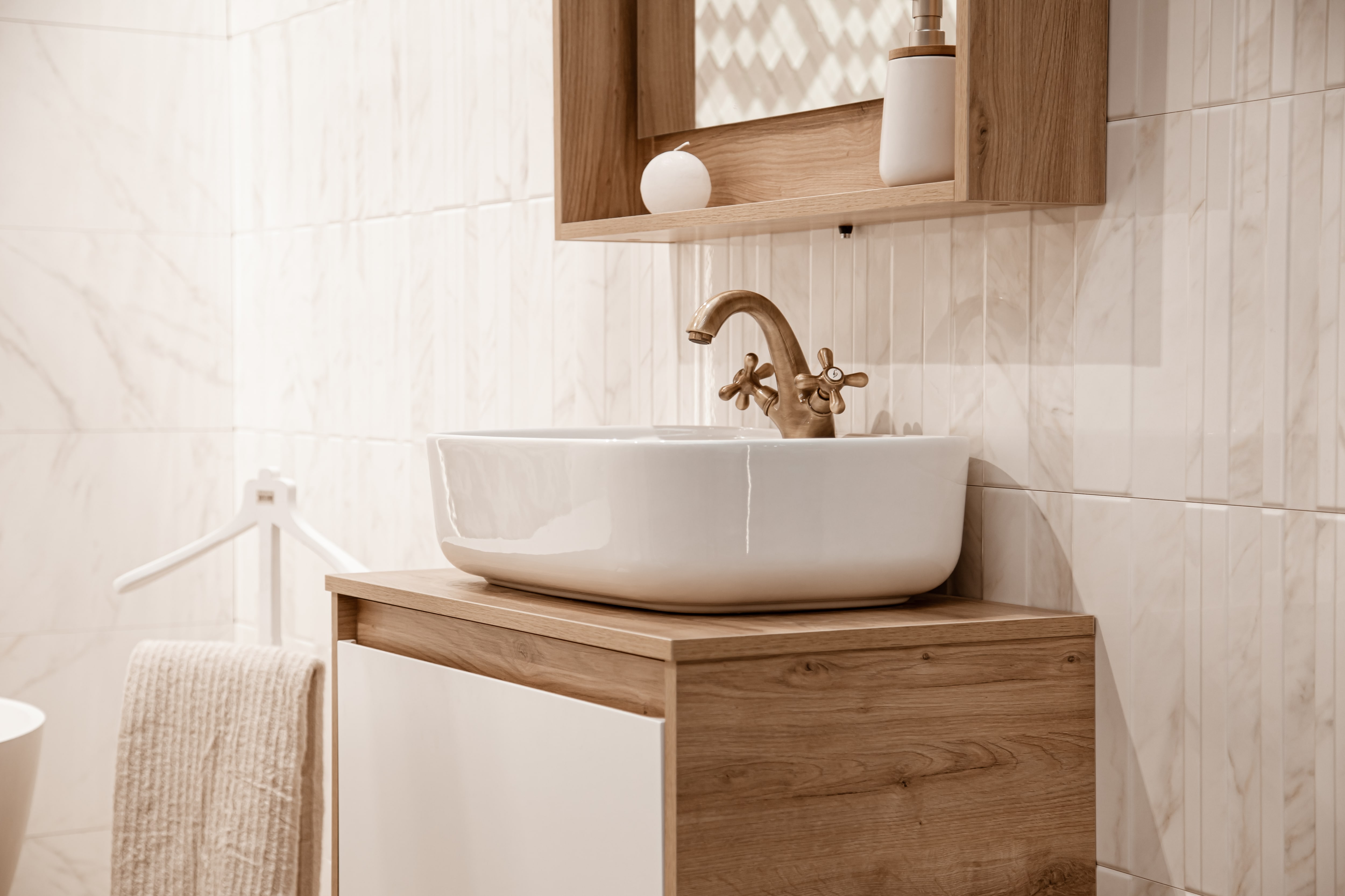 A bathroom with a large wood framed mirror