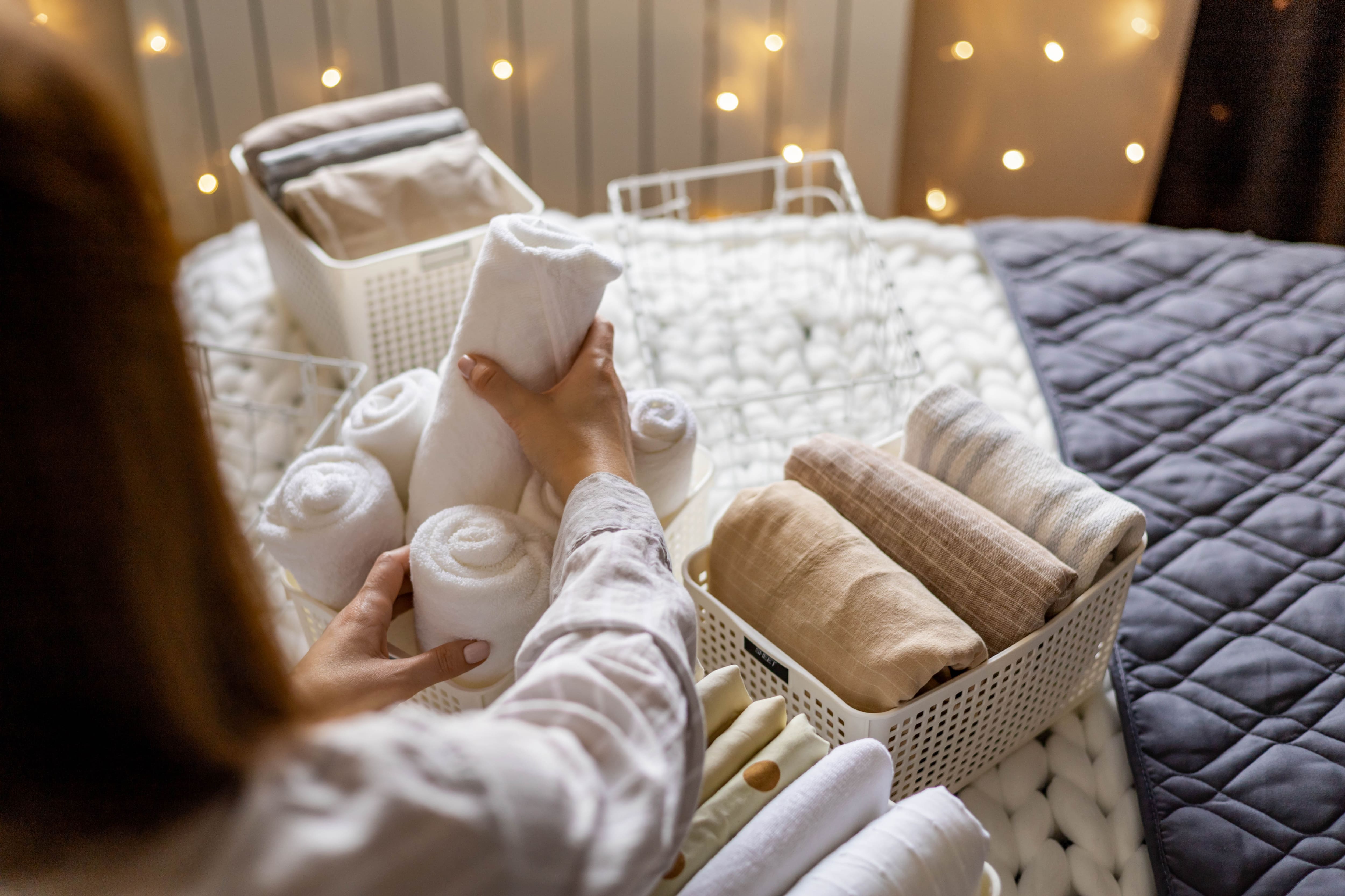 Metal baskets with folded towels and blankets