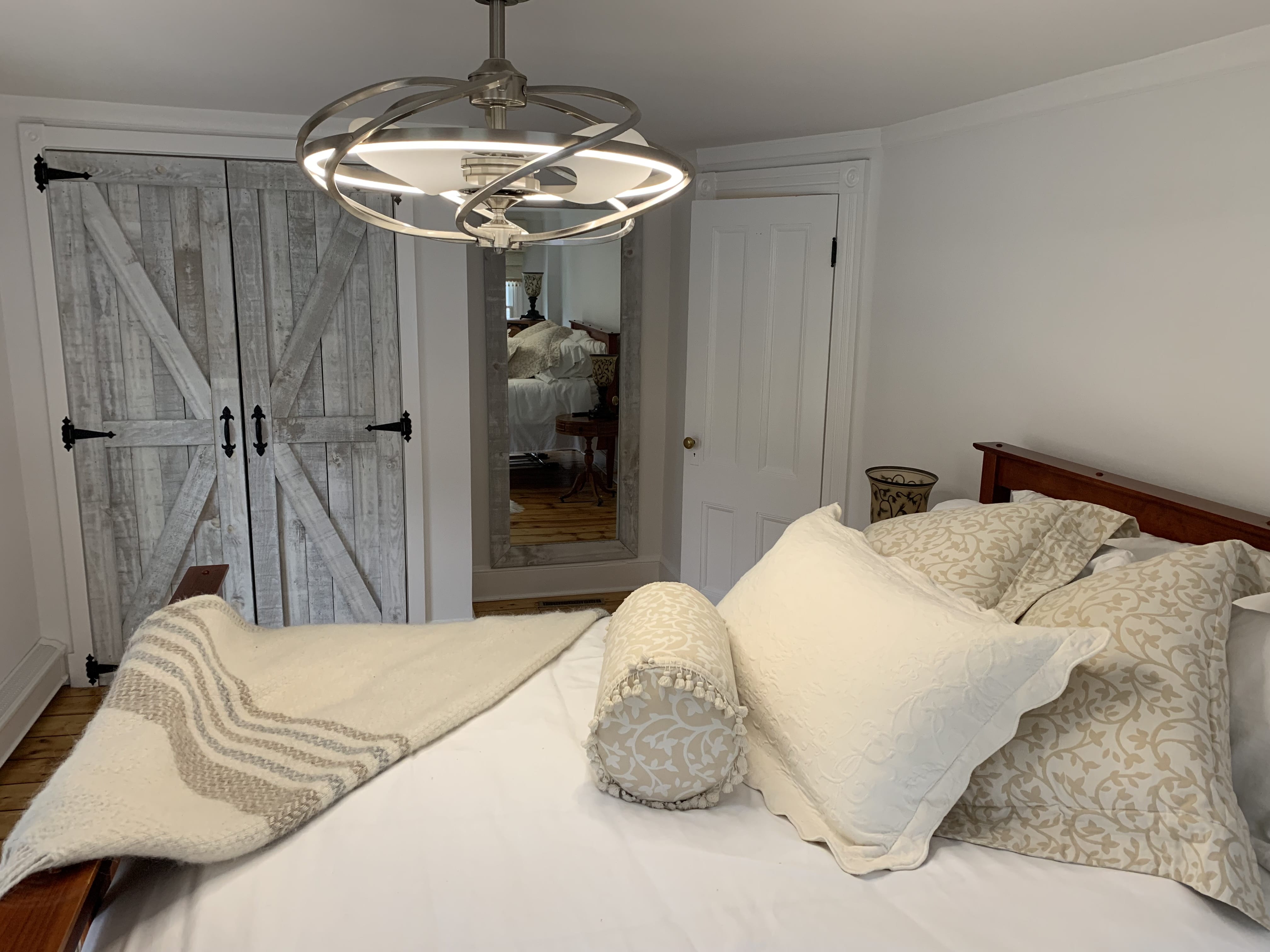 Brushed-aluminum modern chandelier in farmhouse style bedroom