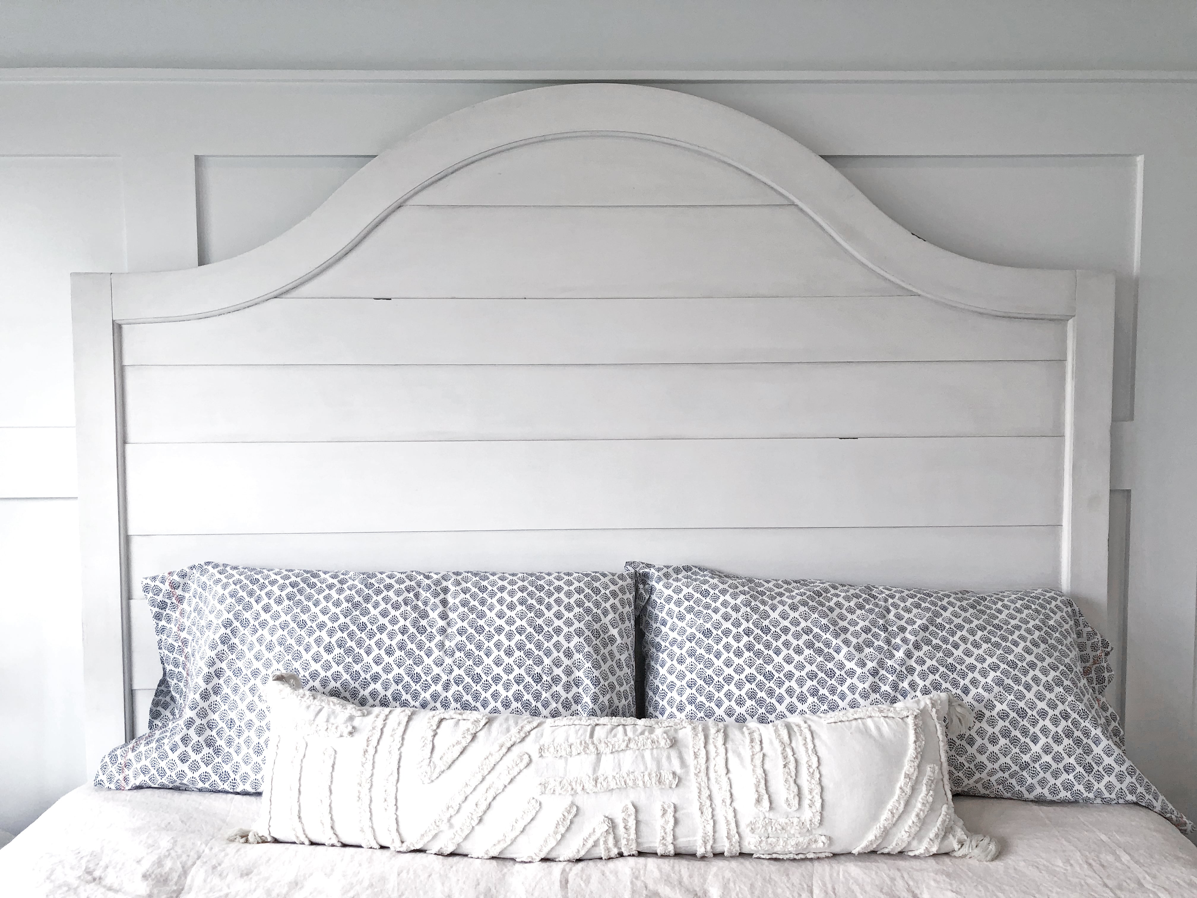 Headboard painted white in rustic bedroom