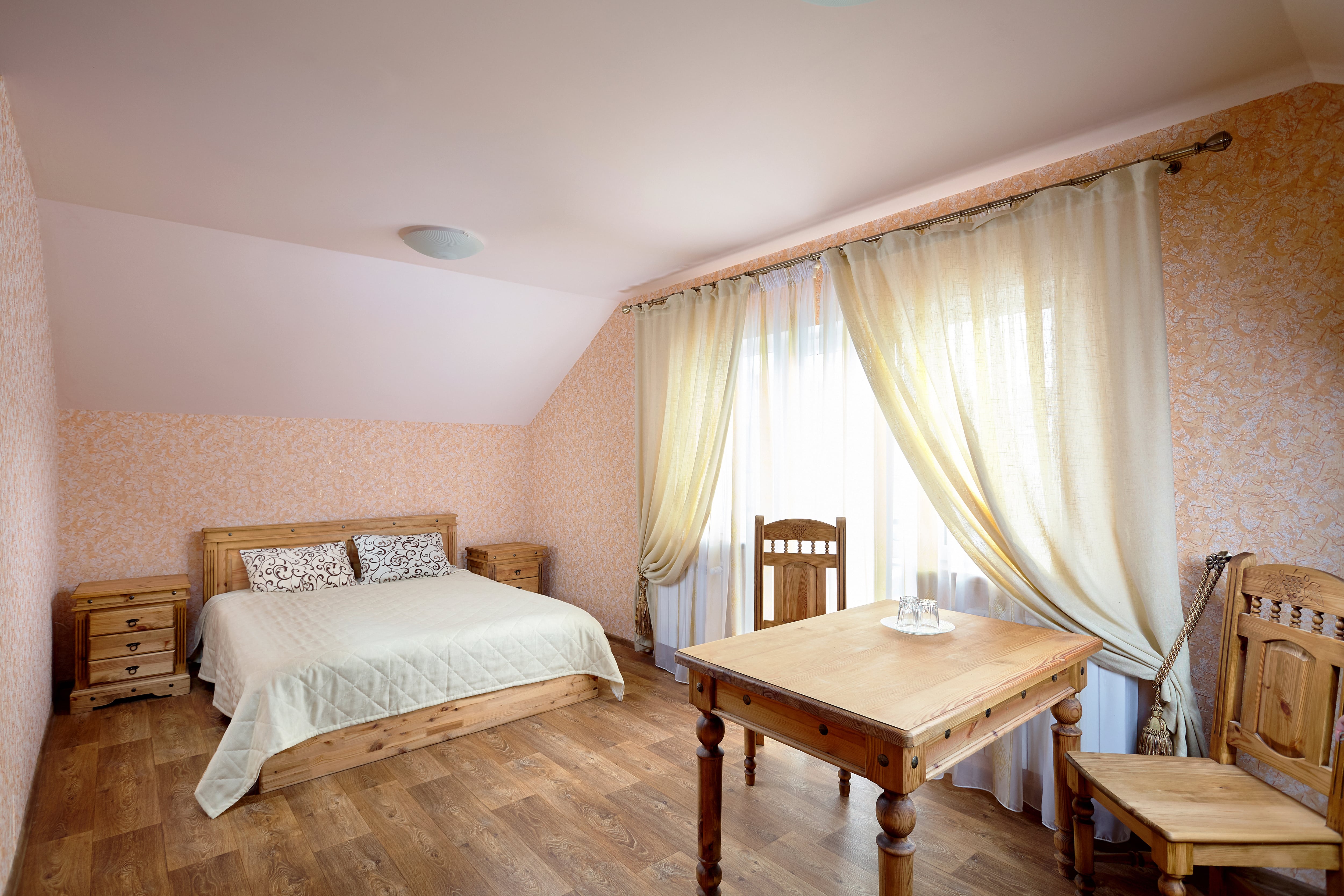 Patterned wallpaper in farmhouse-style bedroom