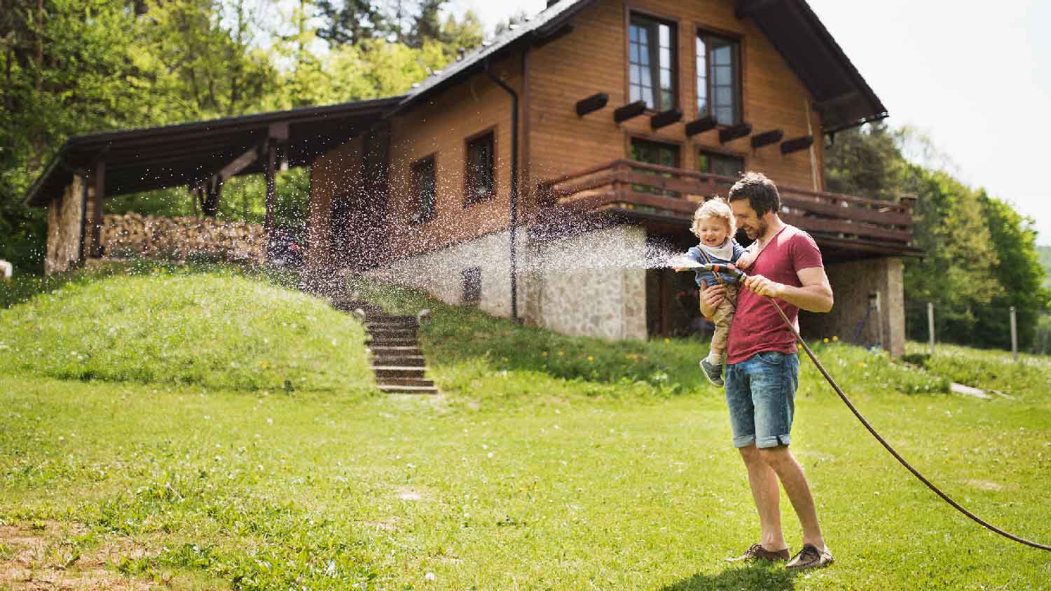 A father with his boy watering the lawn